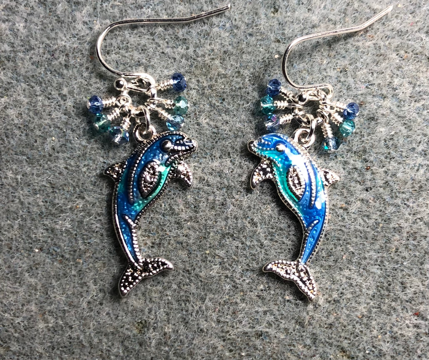 Silver, blue, and turquoise enamel dolphin charm earrings adorned with tiny dangling blue and turquoise Chinese crystal beads.
