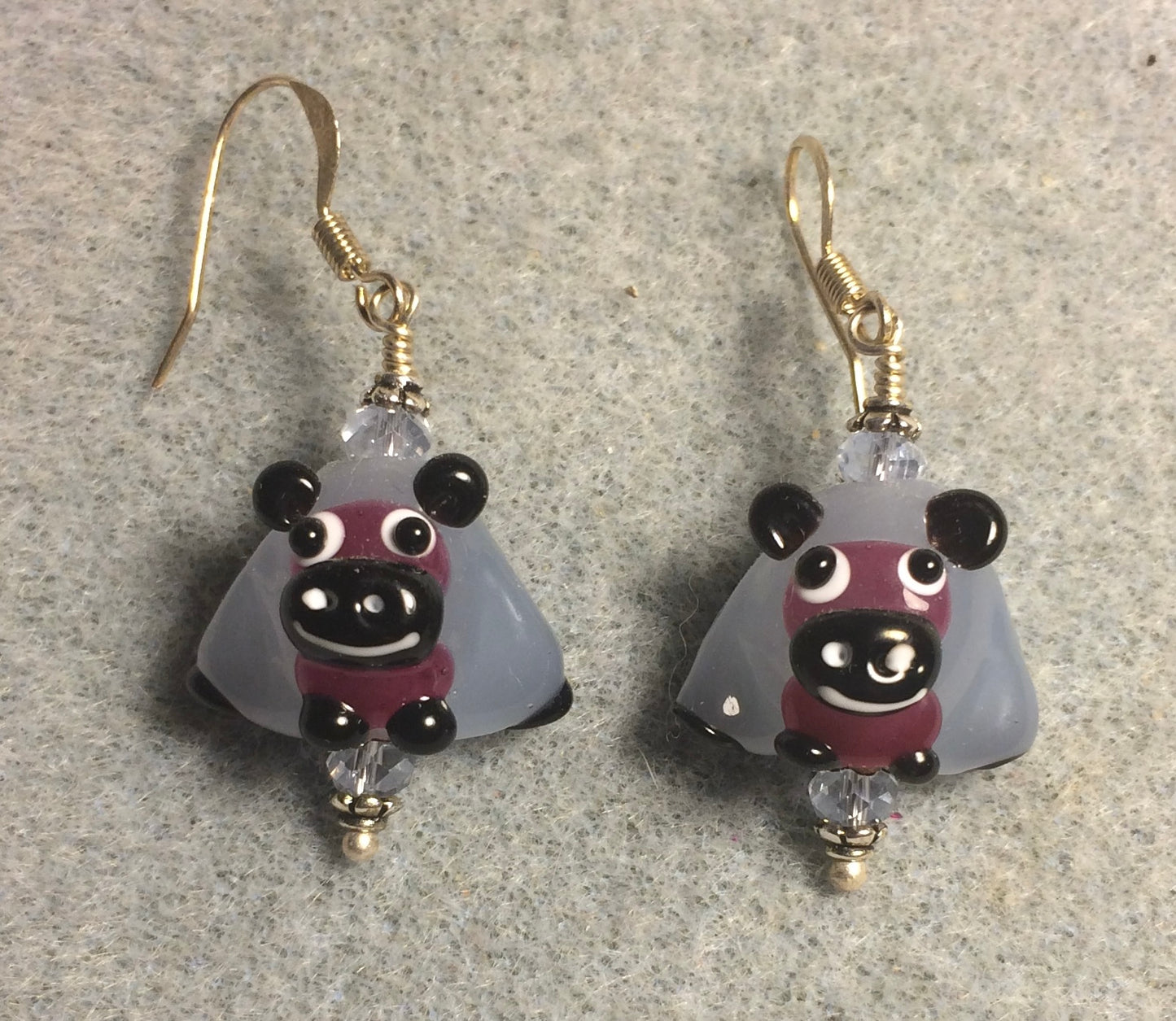 Light blue, purple, and black lamp work sheep bead earrings adorned with light blue Chinese crystal beads.