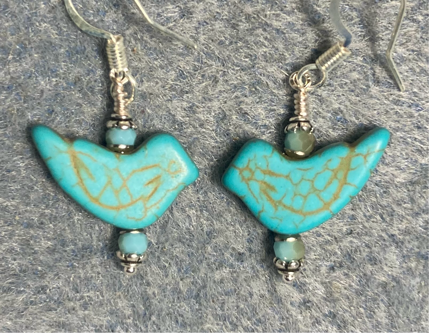 Turquoise howlite gemstone bird bead earrings adorned with turquoise Chinese crystal beads.