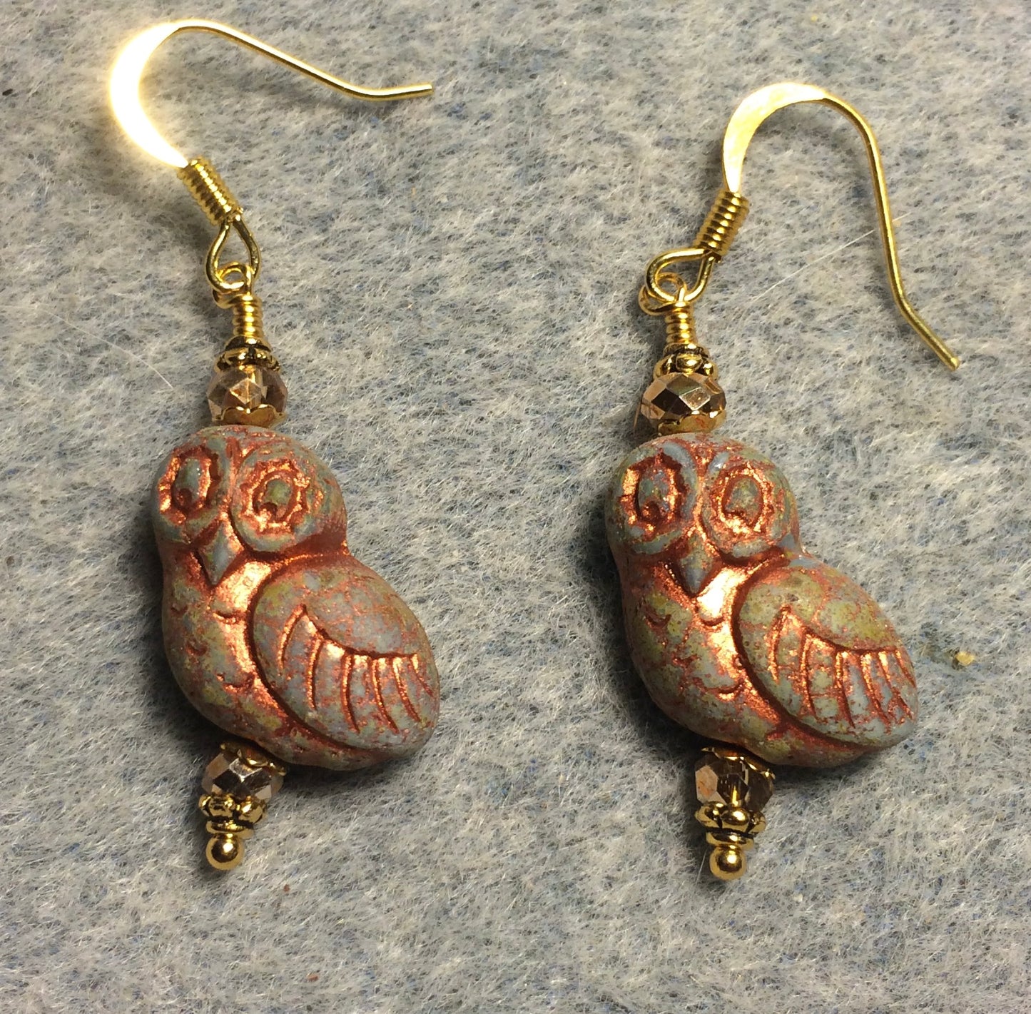 Green (with copper wash) fancy Czech glass owl bead earrings adorned with gold Chinese crystal beads.