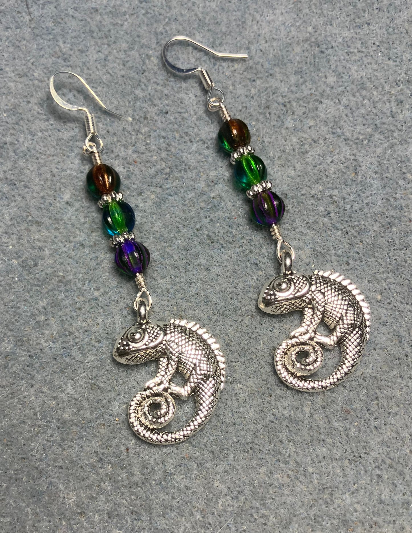 Large silver chameleon charm earrings adorned with green, purple green, and orange green Czech glass melon beads.