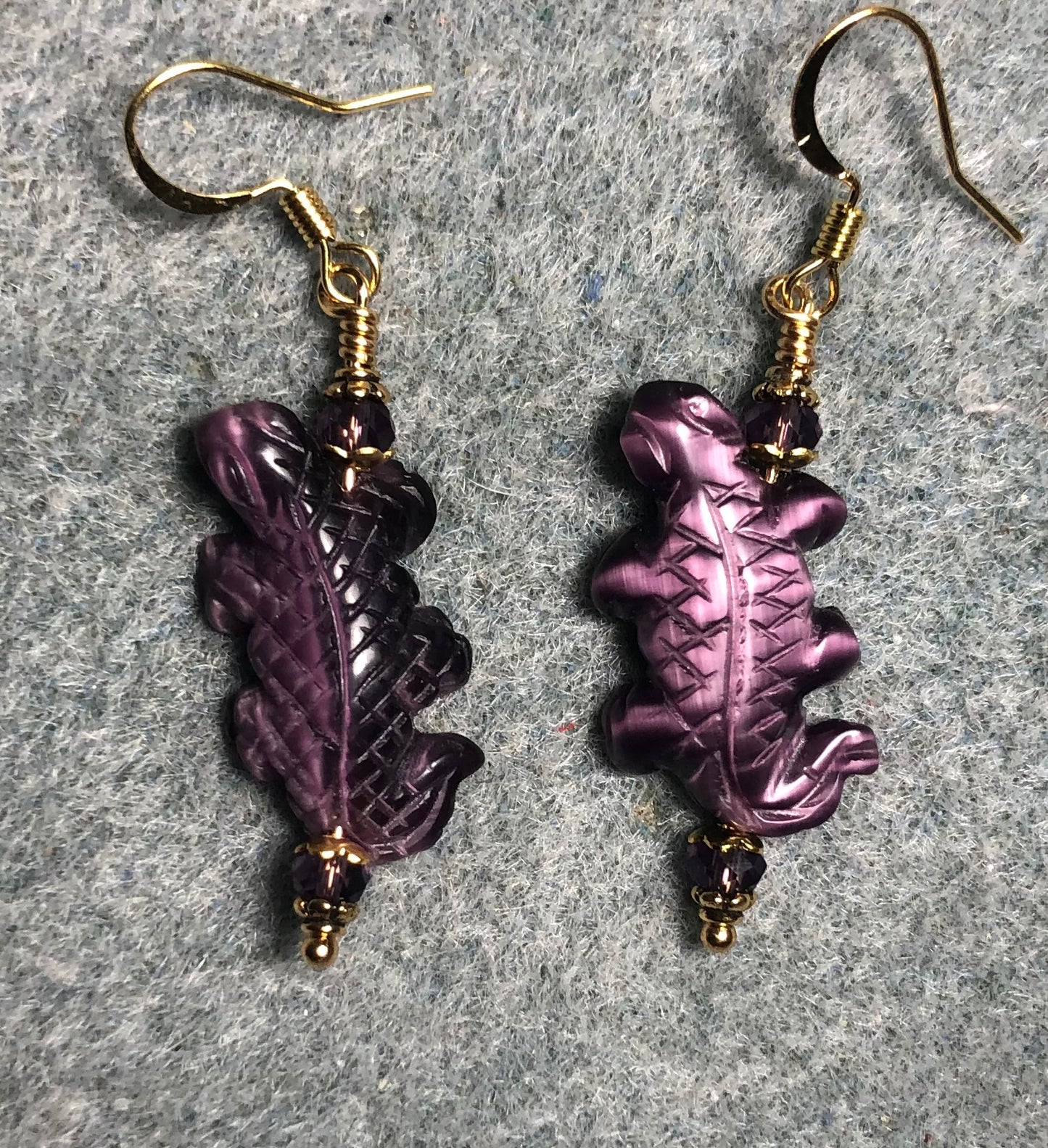 Purple fiber optic (cat’s eye) lizard bead earrings adorned with purple Chinese crystal beads.