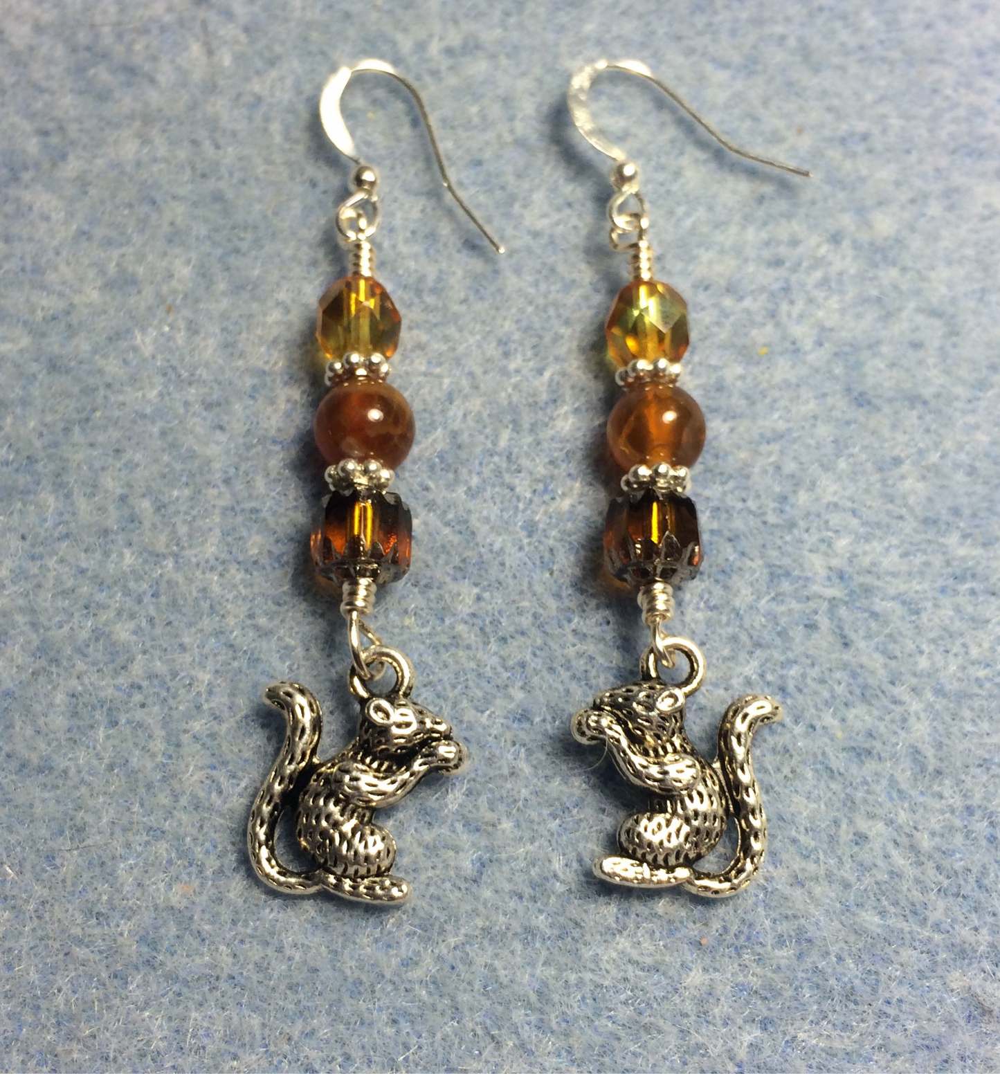 Silver squirrel charm earrings adorned with amber Czech glass beads