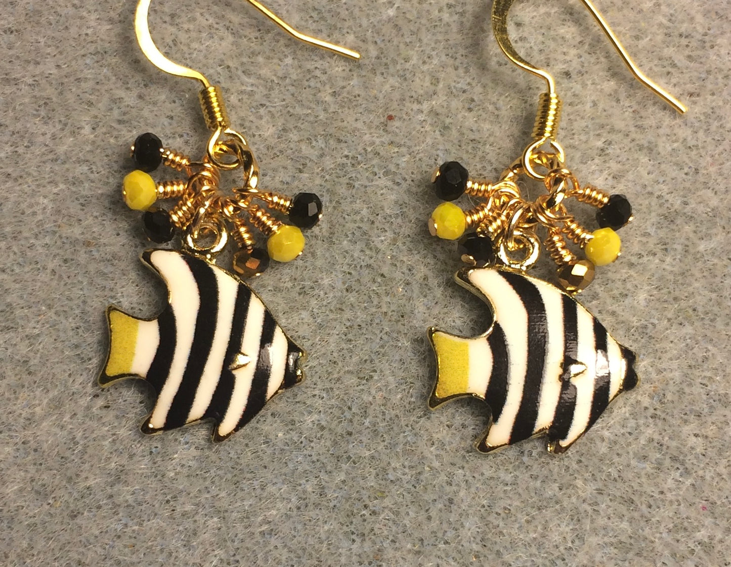 Black, yellow, and white enamel striped angelfish charm earrings adorned with tiny dangling black, yellow, and gold Chinese crystal beads.