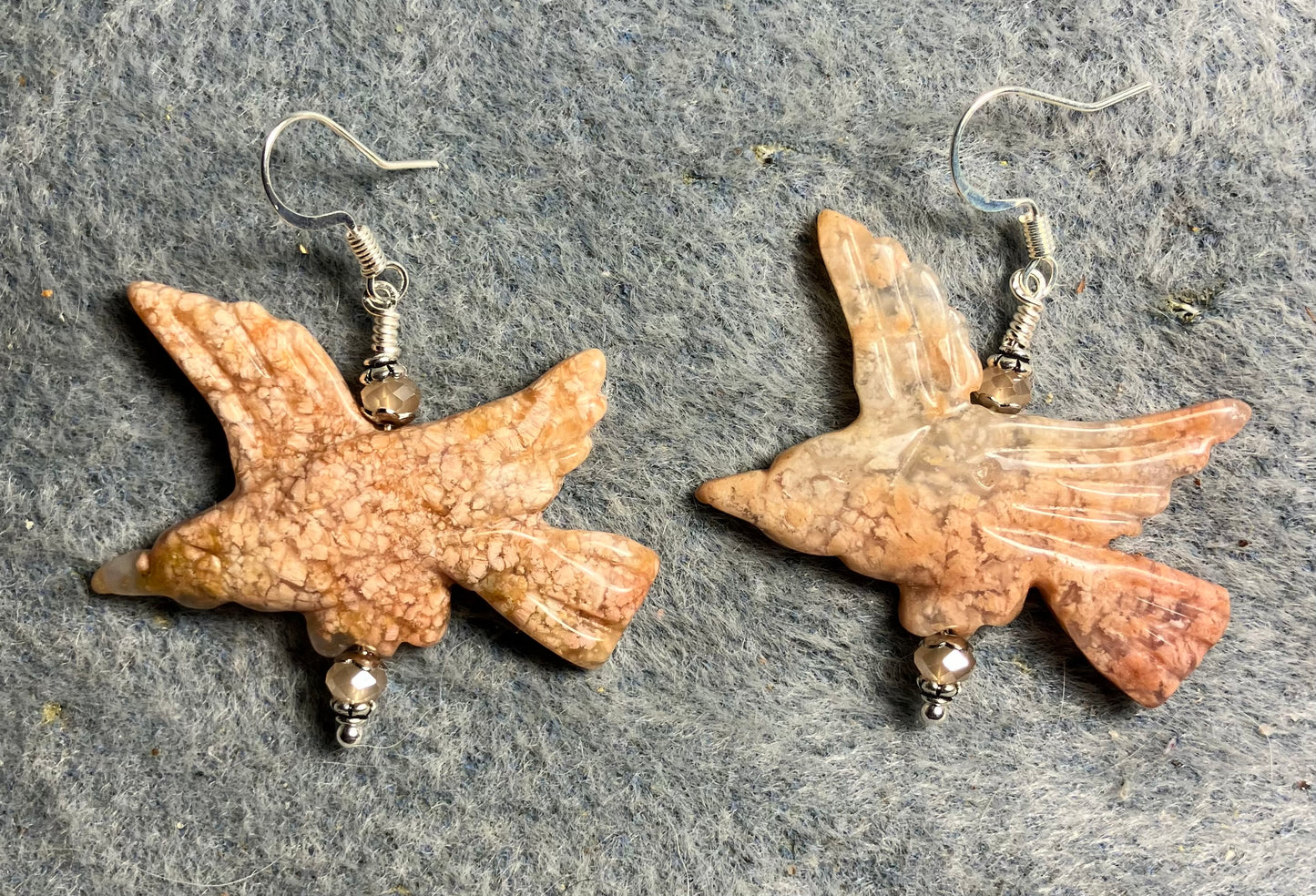 Large pink agate gemstone flying eagle bead earrings adorned with peach Chinese crystal beads.