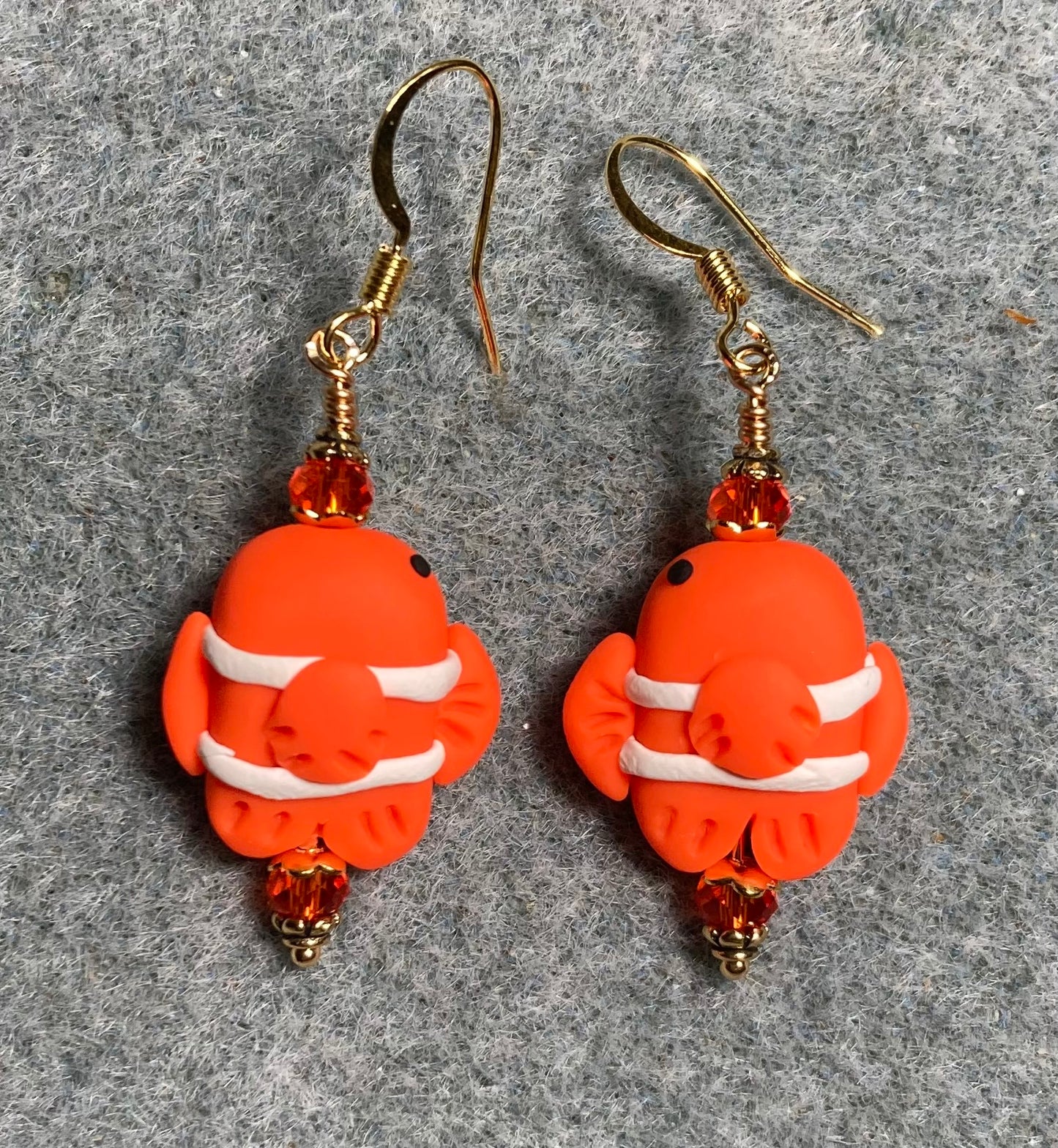 Orange and white polymer clay goldfish bead earrings adorned with orange Chinese crystal beads.