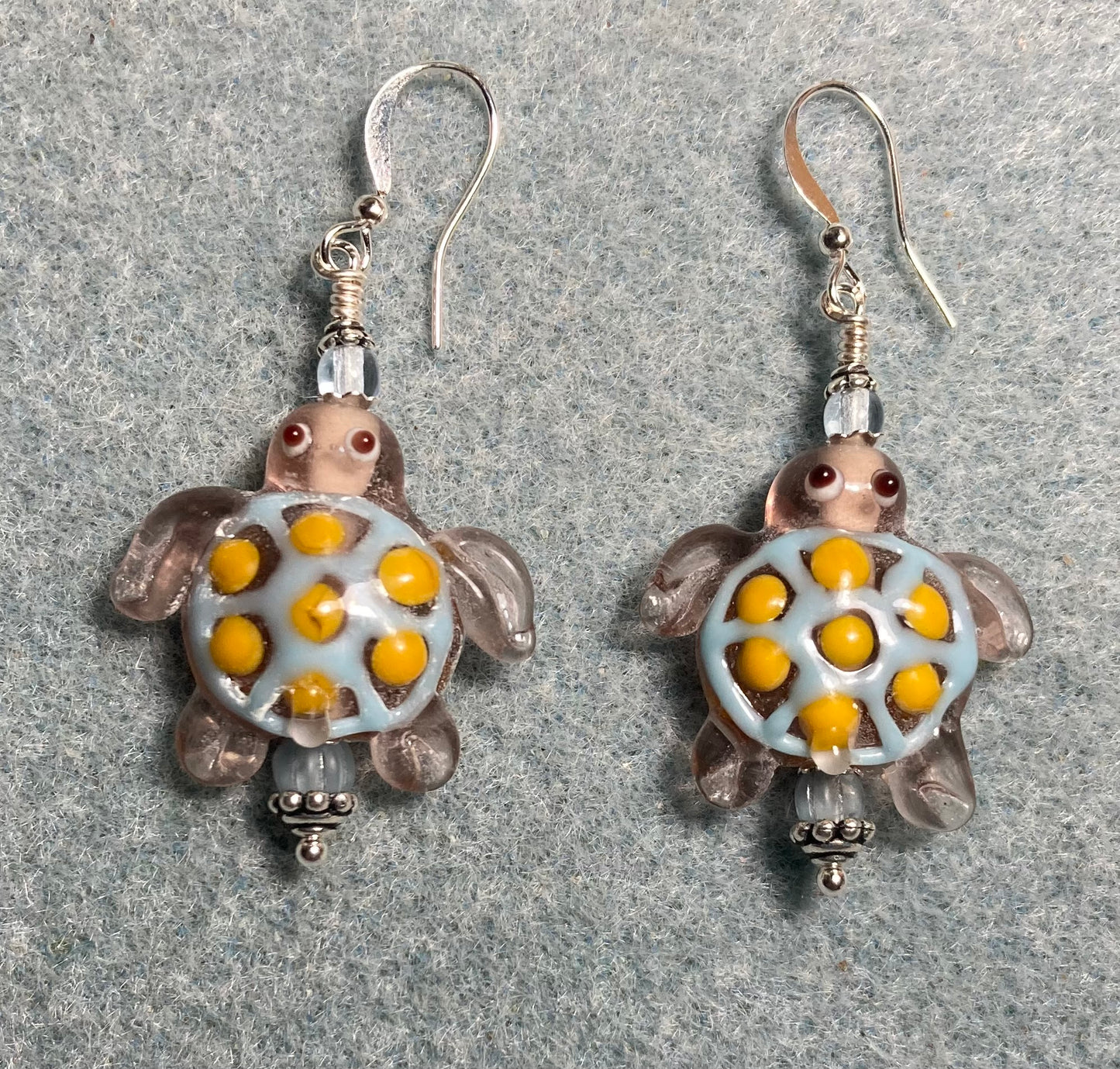 Light blue and yellow lamp work spotted turtle bead earrings adorned with light blue Czech glass beads.