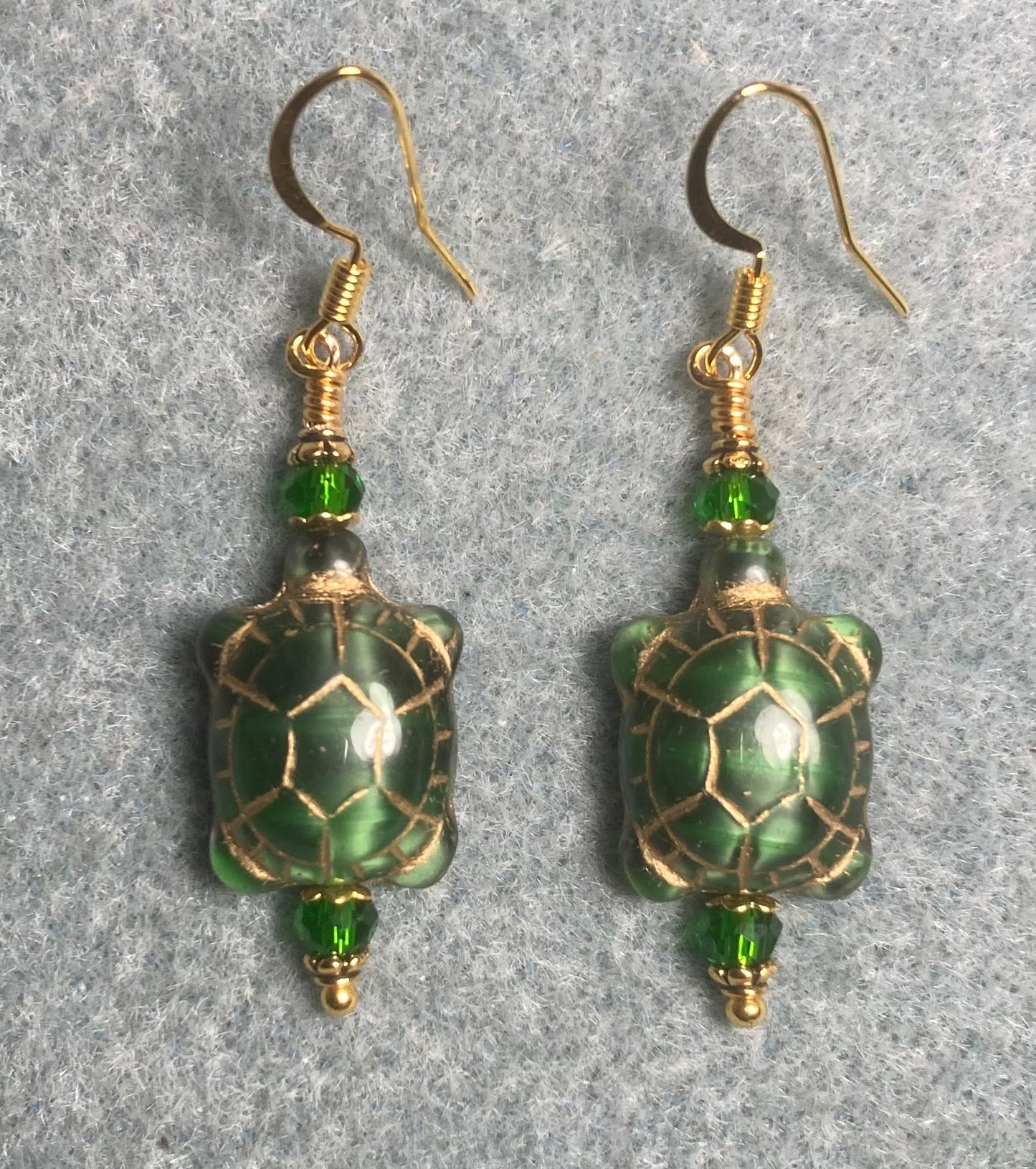 Emerald green (with gold wash) Czech glass turtle bead earrings adorned with green Chinese crystal beads.