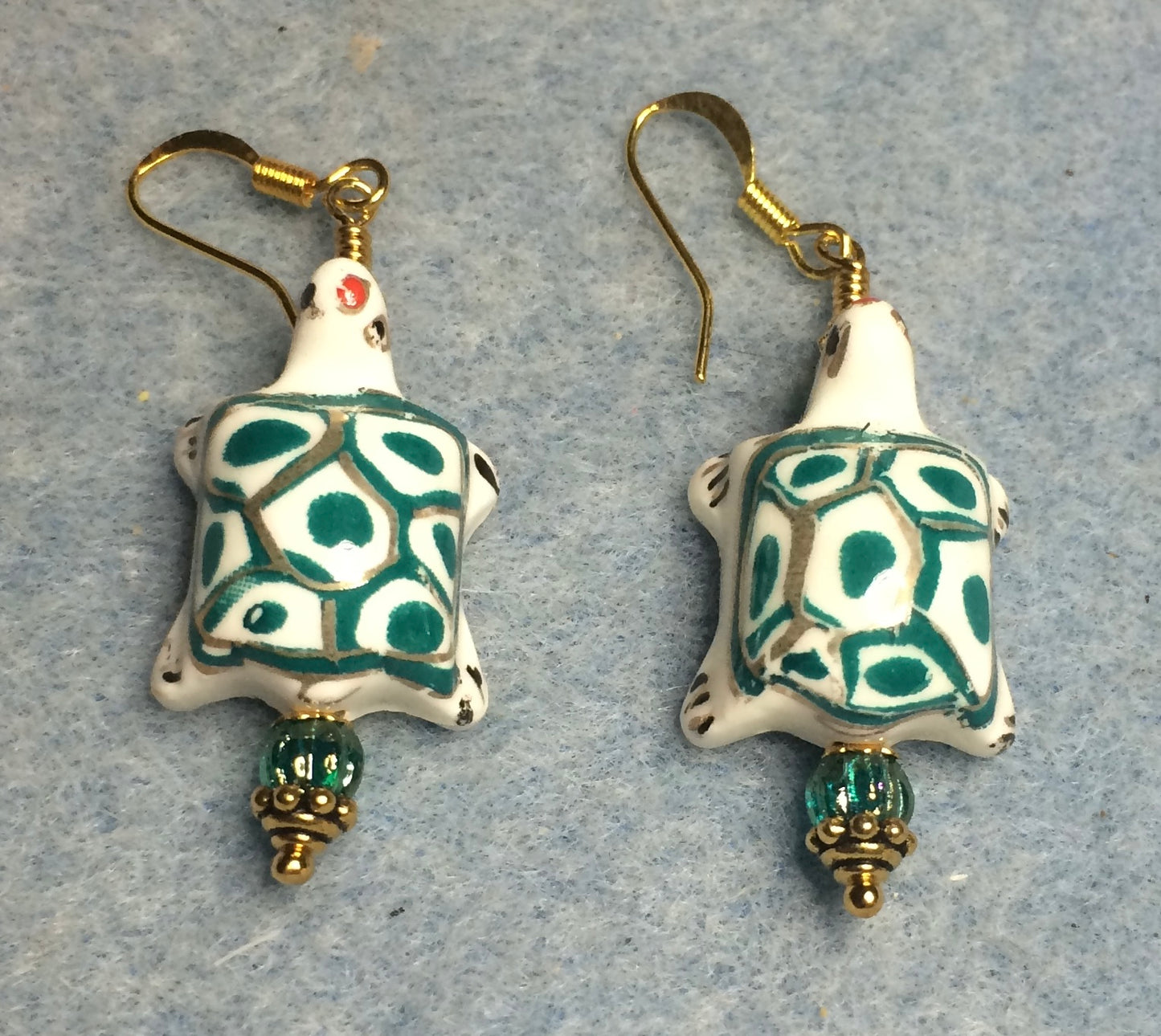 Teal and white ceramic spotted turtle bead earrings adorned with teal Czech glass beads.