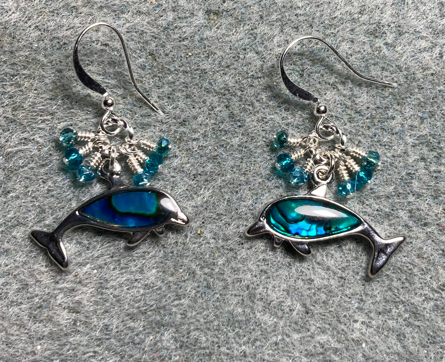 Silver and turquoise abalone dolphin charm earrings adorned with tiny dangling turquoise Chinese crystal beads.