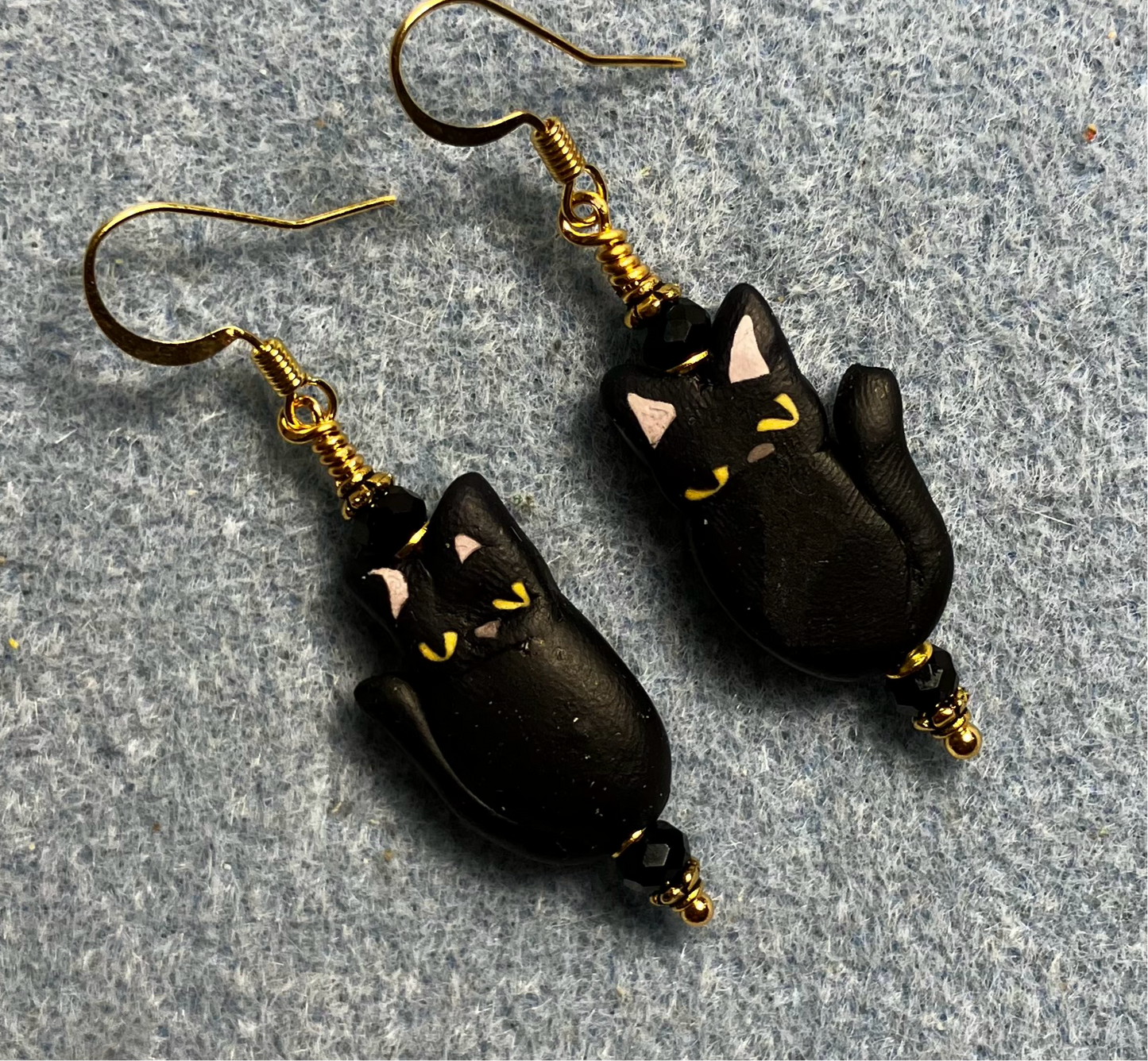 Black polymer clay cat bead earrings adorned with black Chinese crystal beads.