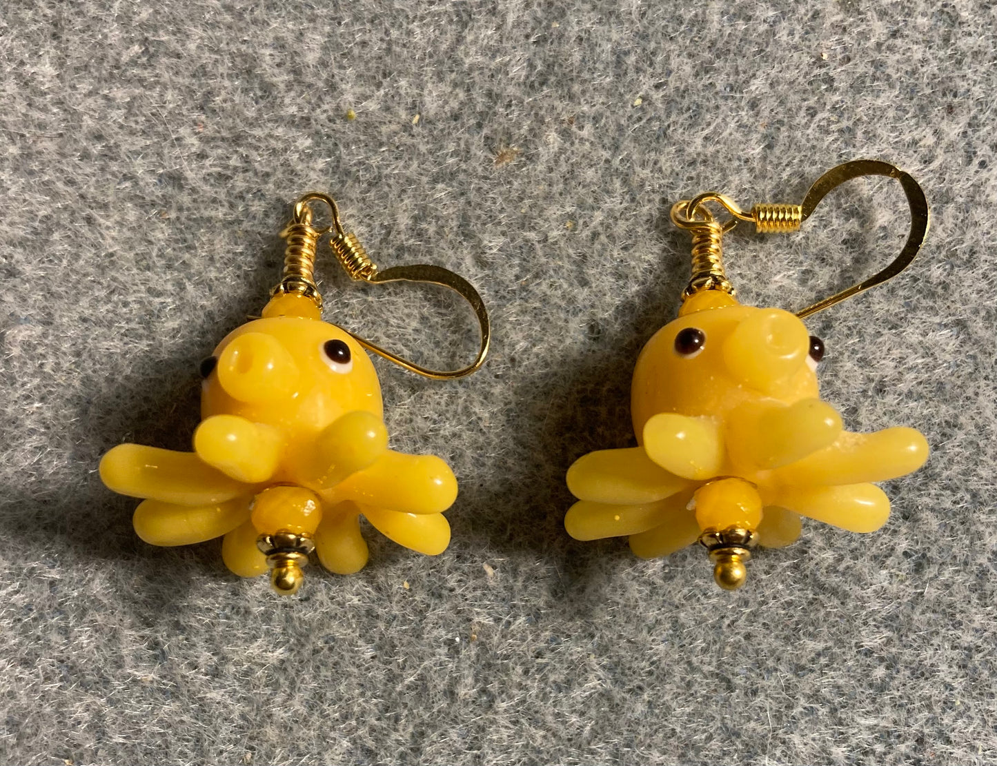 Yellow amber lamp work octopus bead earrings adorned with yellow amber Chinese crystal beads.
