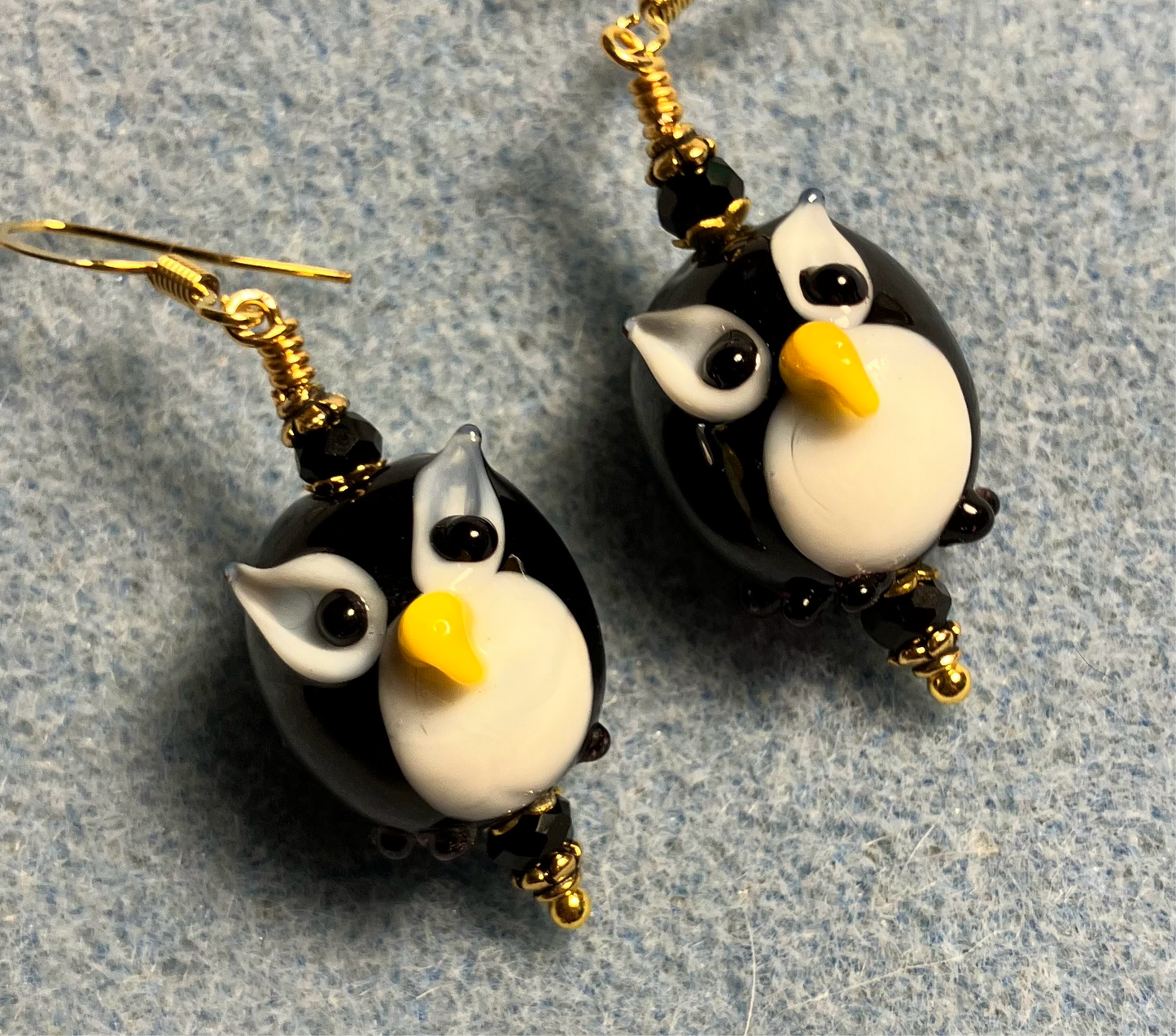 Black and white lamp work owl bead earrings adorned with black Chinese crystal beads.
