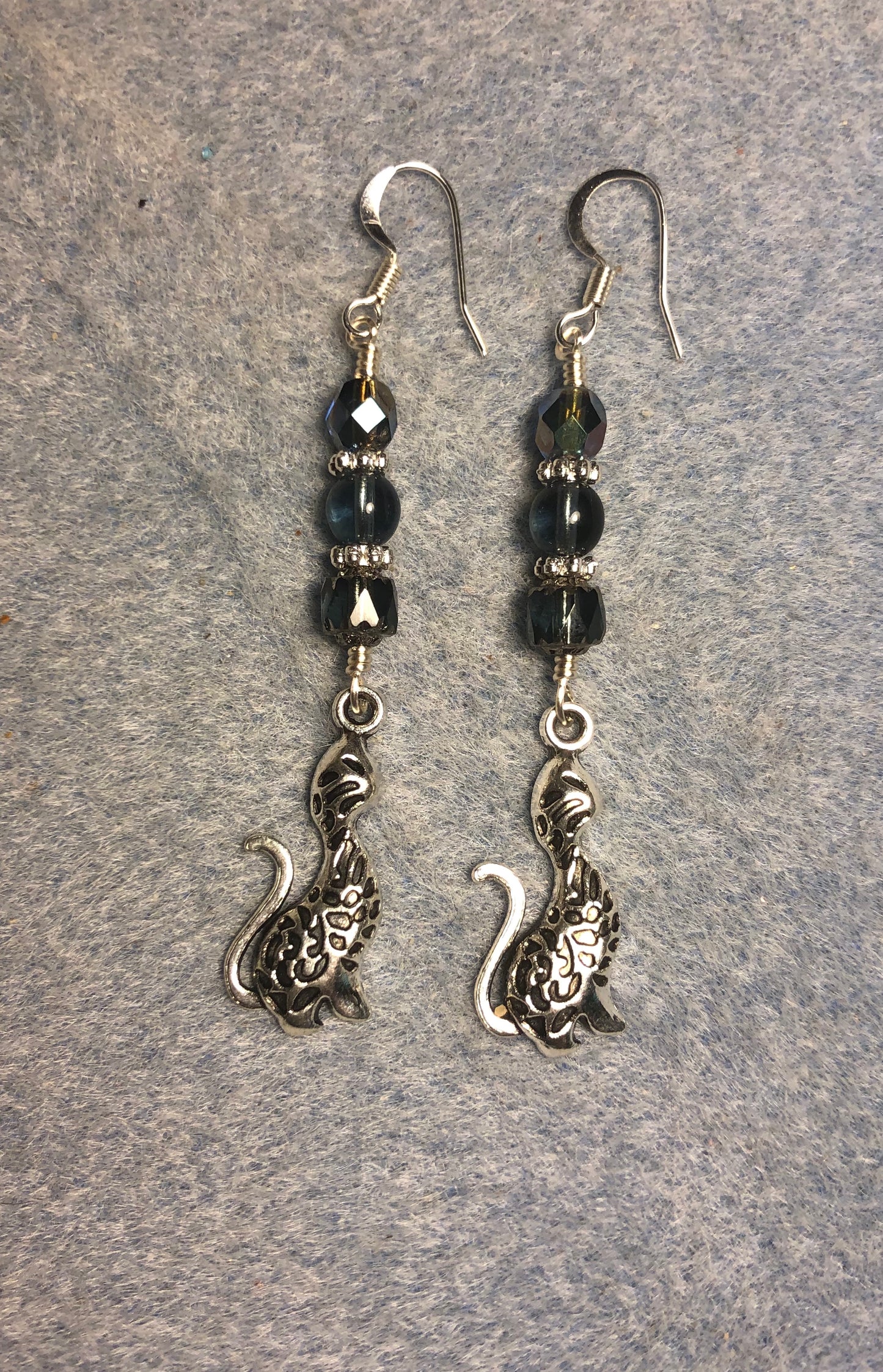 Long silver cat charm earrings adorned with Montana blue Czech glass beads