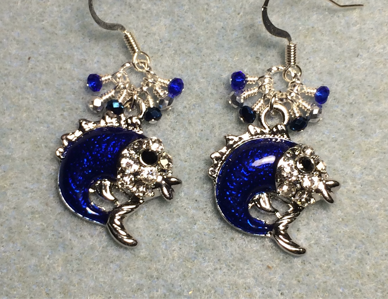 Dark blue enamel and rhinestone dolphin charm earrings adorned with tiny dangling dark blue, silver, and black Chinese crystal beads.