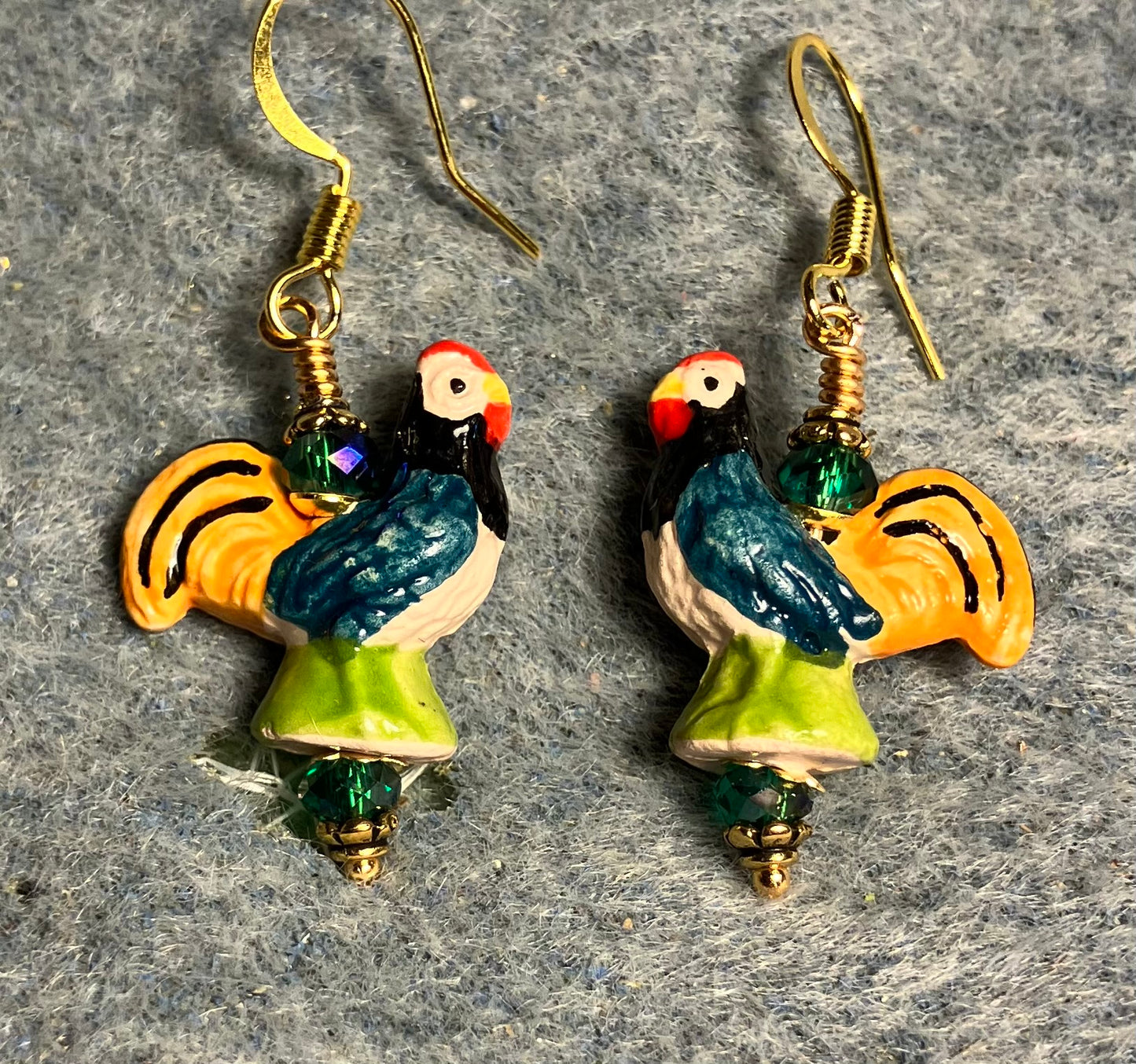 Small teal, tangerine, and green ceramic chicken bead earrings adorned with teal Chinese crystal beads.