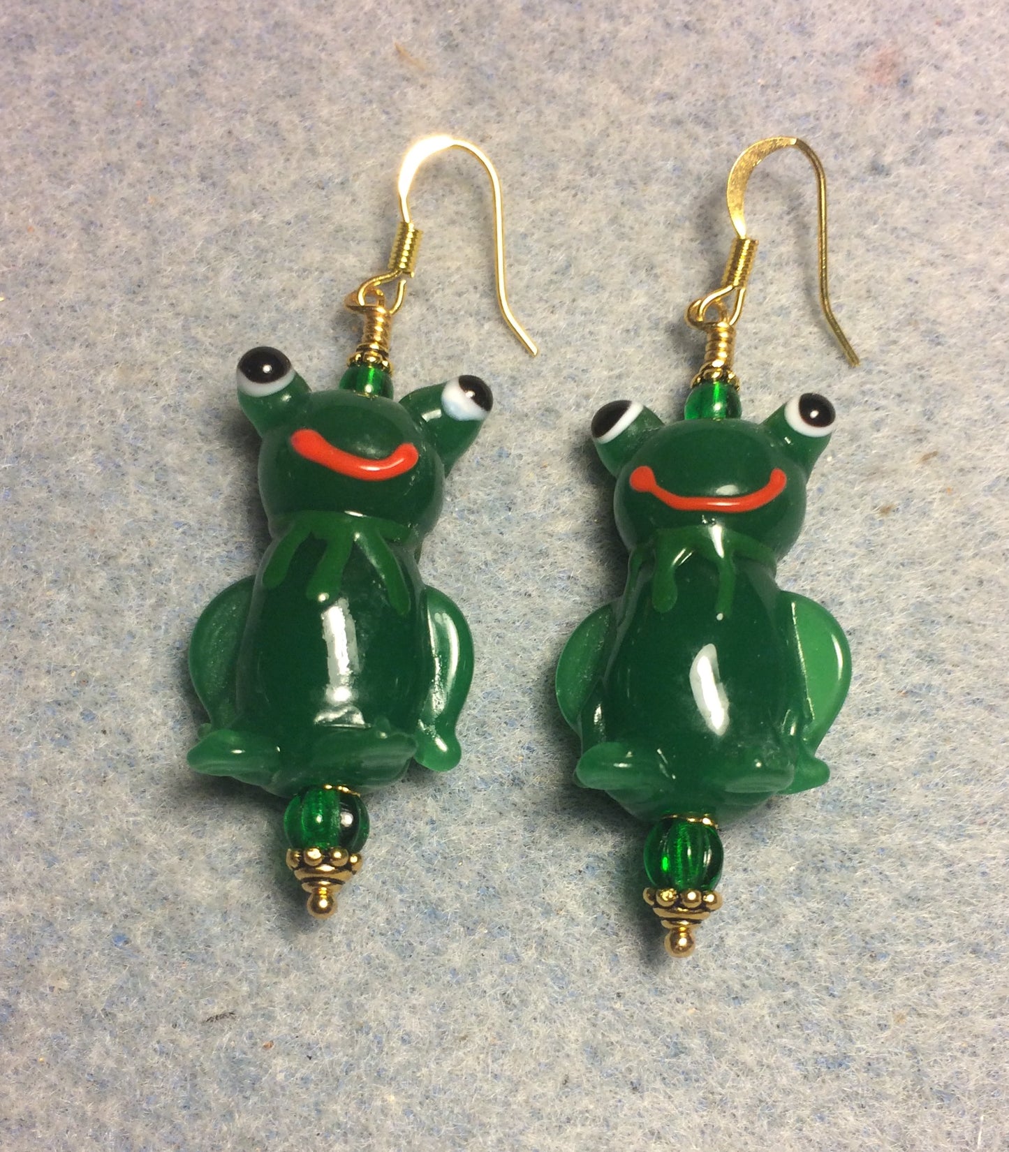 Large green lamp work silly frog bead earrings adorned with green Czech glass beads.