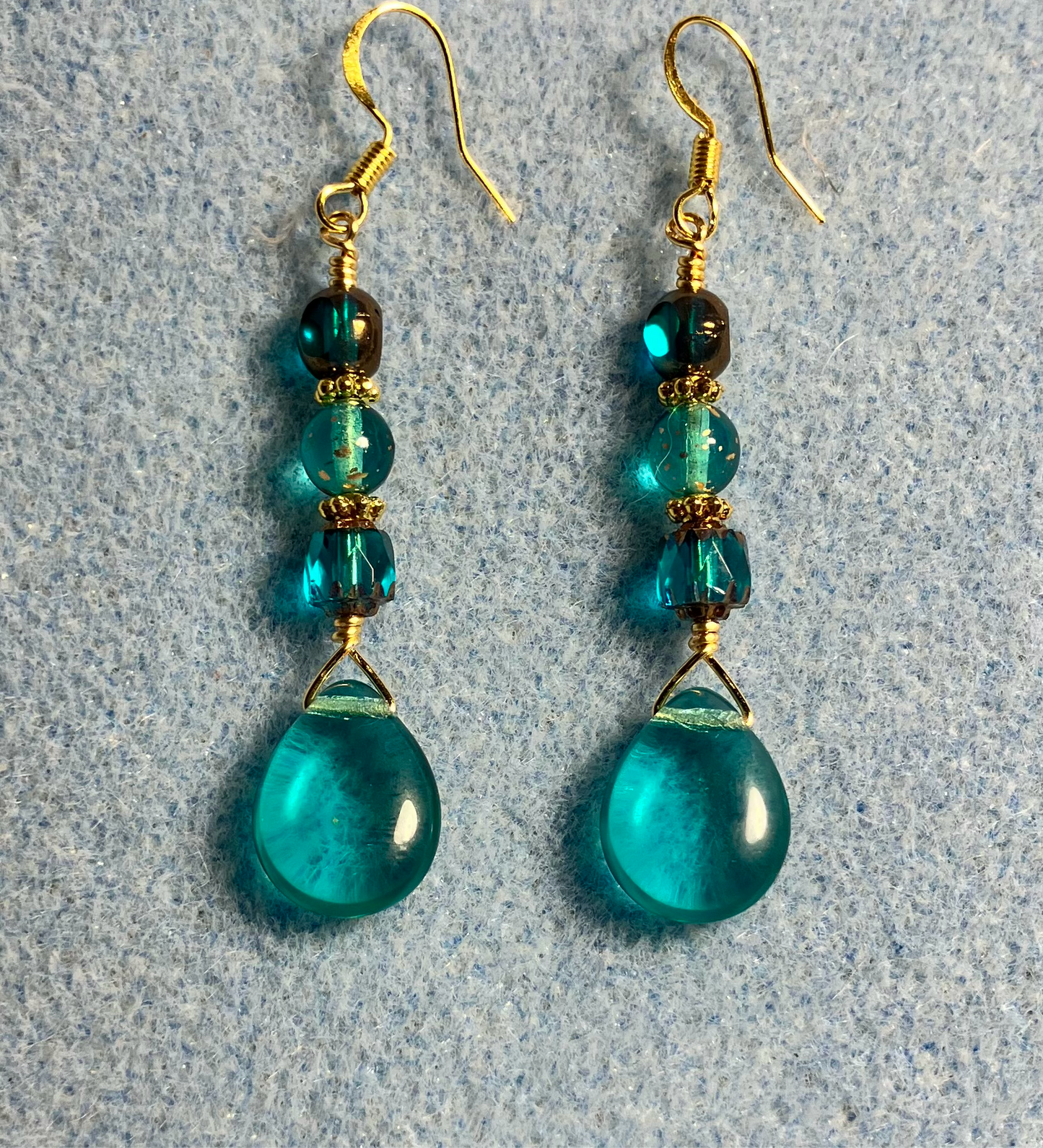Translucent teal Czech glass pear drop bead earrings adorned with teal Czech glass beads.