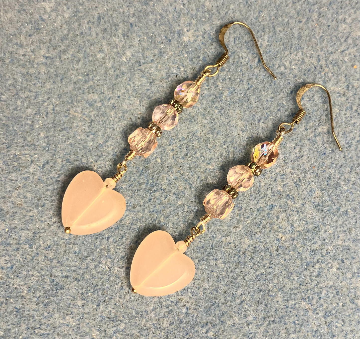 Frosty pink Czech glass heart bead earrings adorned with pink Czech glass beads.