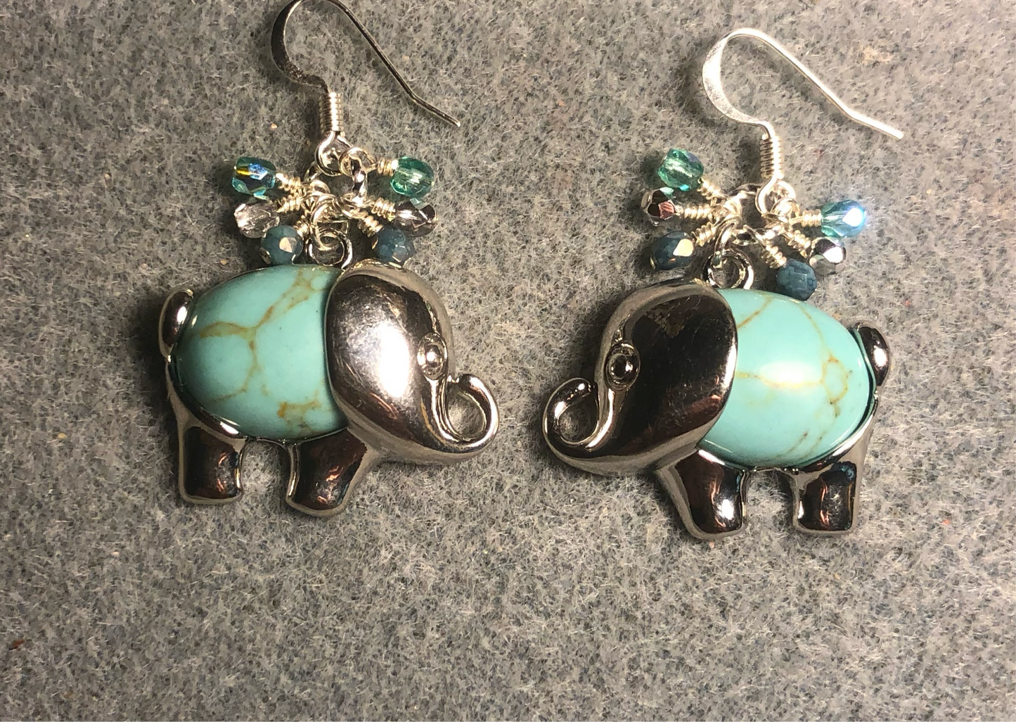 Large silver and light turquoise gemstone elephant charm earrings adorned with small dangling light turquoise and silver Czech glass beads.