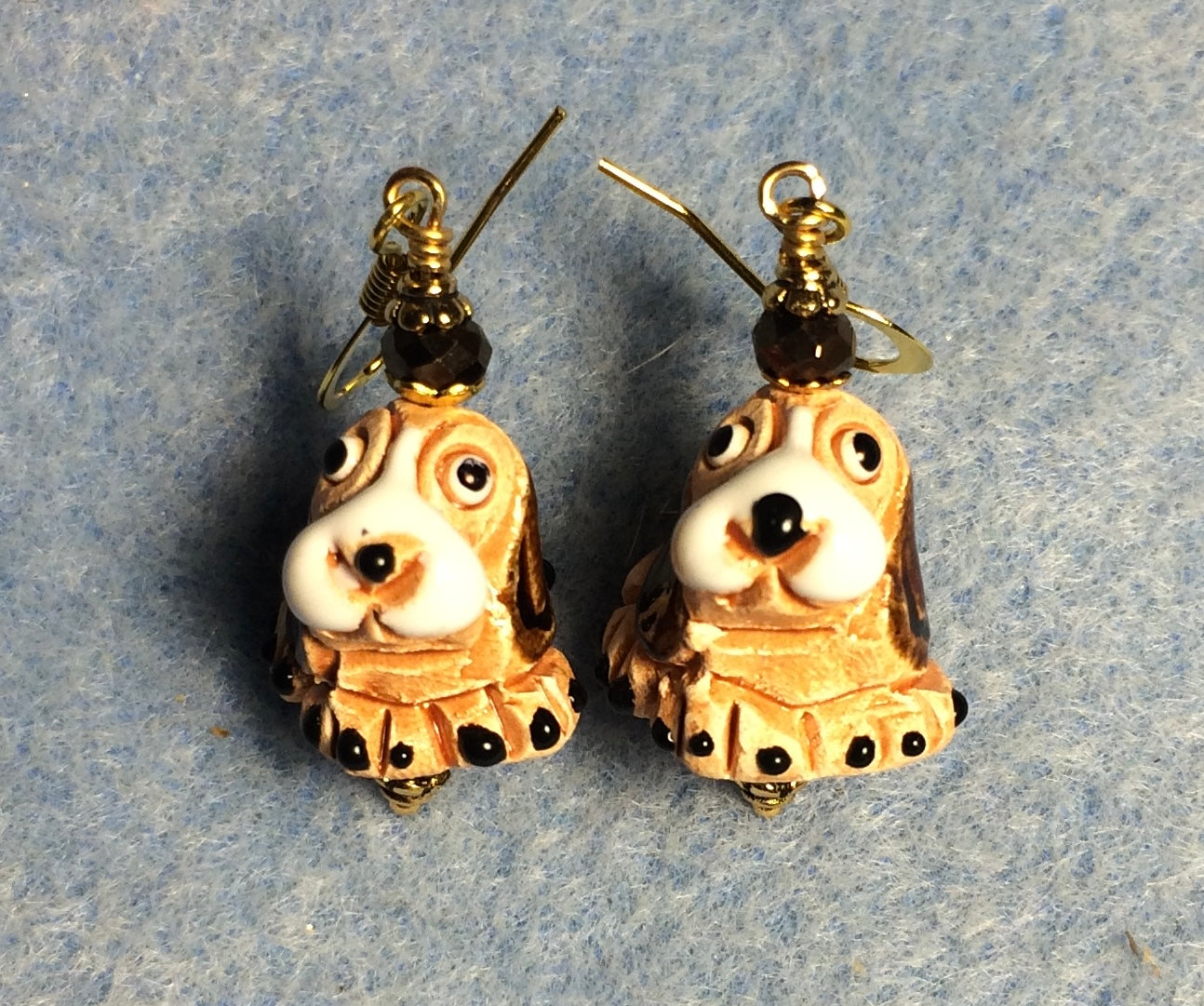 Small tan, brown, and white ceramic hound dog bead earrings adorned with brown Chinese crystal beads.