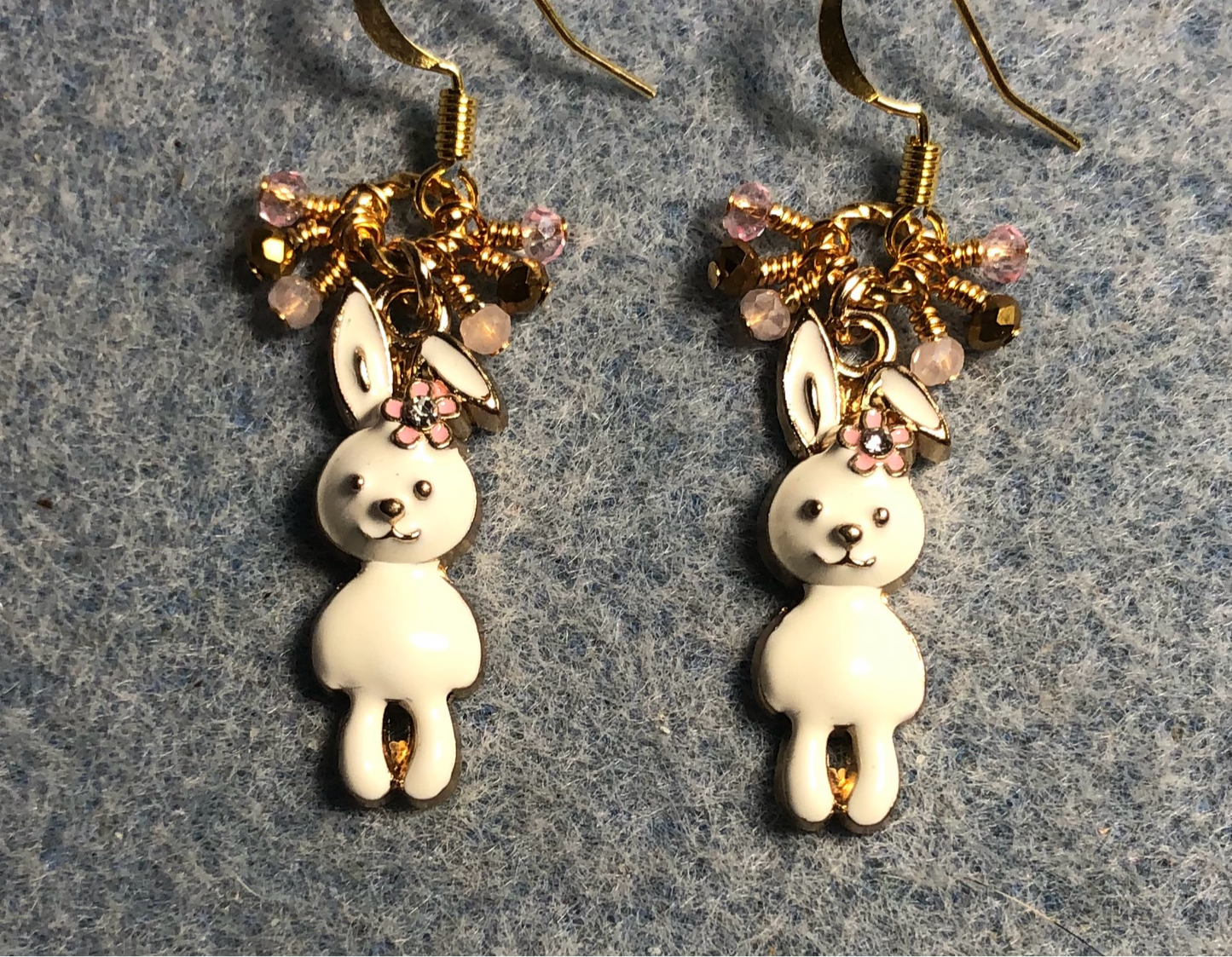 Off white enamel and rhinestone rabbit charm earrings adorned with white, pink, and gold Chinese crystal beads.