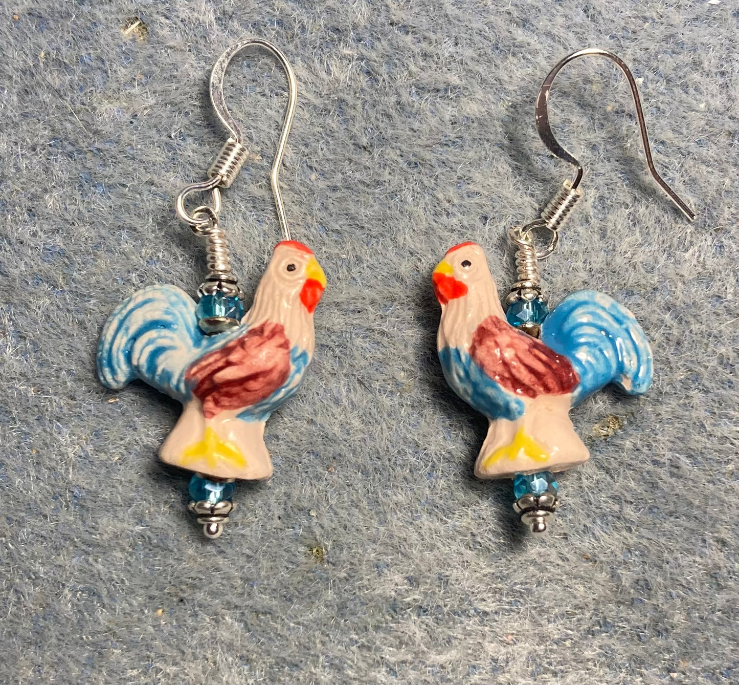 Small turquoise, dark red, and yellow ceramic chicken bead earrings adorned with turquoise Chinese crystal beads.