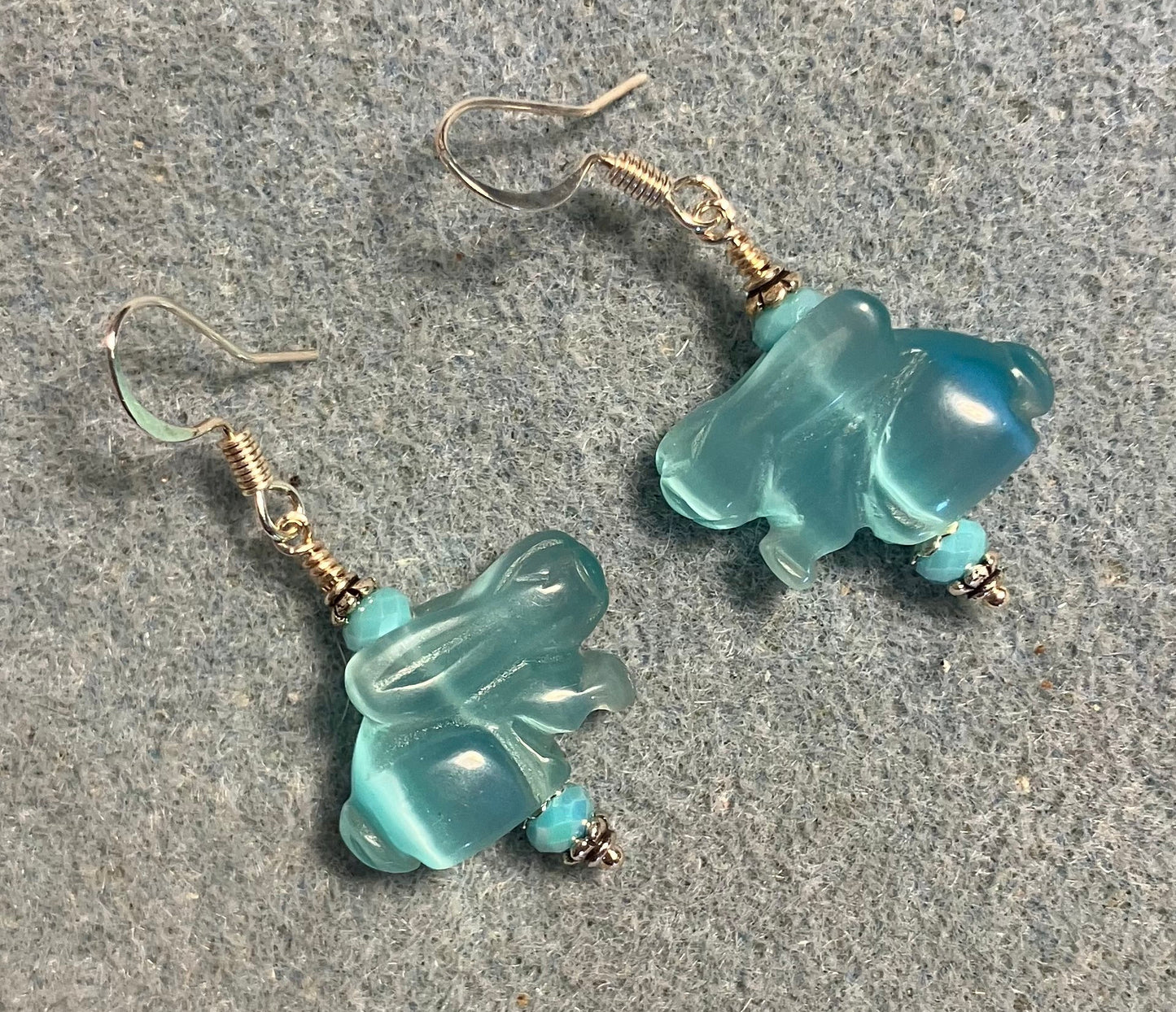 Turquoise fiber optic (cat’s eye) rabbit bead earrings adorned with turquoise Chinese crystal beads.