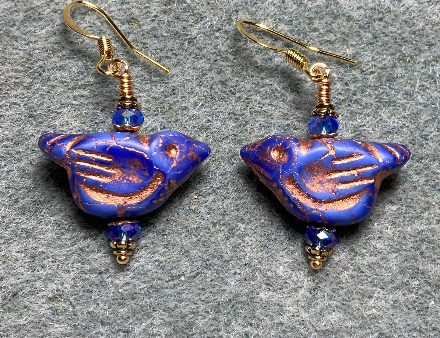 Opaque blue (with copper wash) Czech glass bird bead earrings adorned with blue Chinese crystal beads.