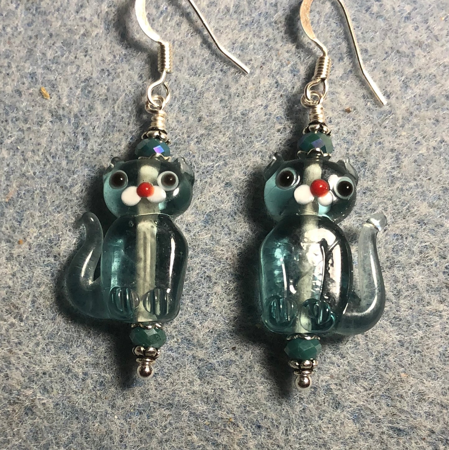 Translucent light turquoise lamp work cat bead earrings adorned with turquoise Chinese crystal beads.
