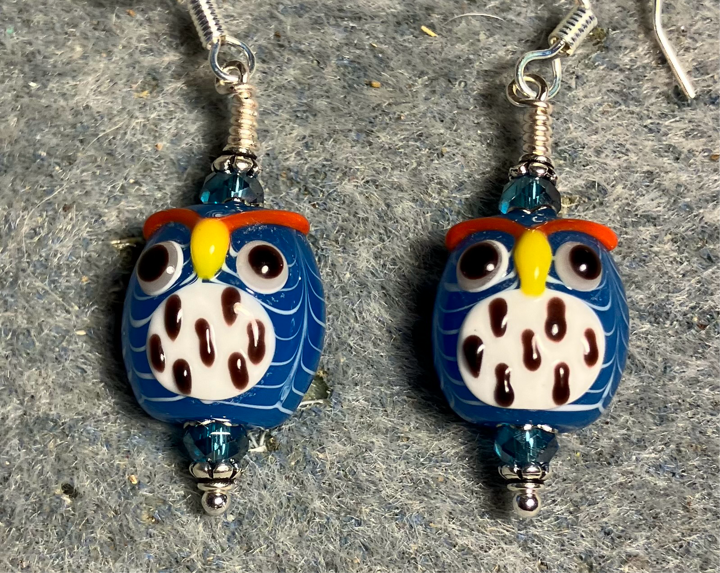 Turquoise and white lamp work spotted owl bead earrings adorned with turquoise Chinese crystal beads.