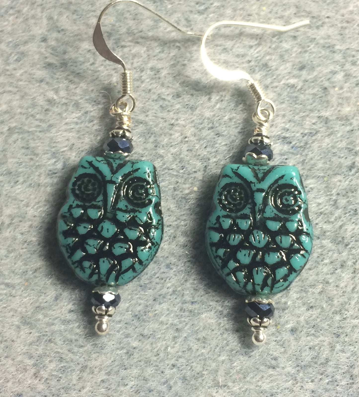 Teal (with black wash) Czech glass owl bead earrings adorned with teal Chinese crystal beads.