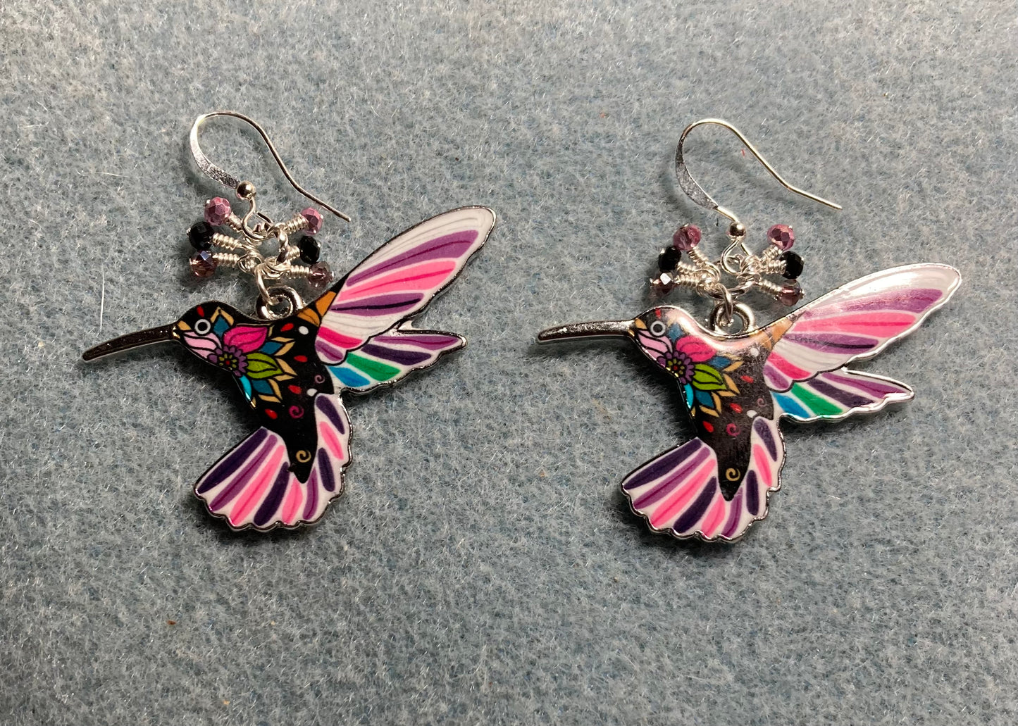 Large pink, black, and purple enamel hummingbird charm earrings adorned with tiny dangling pink, black, and purple Chinese crystal beads.