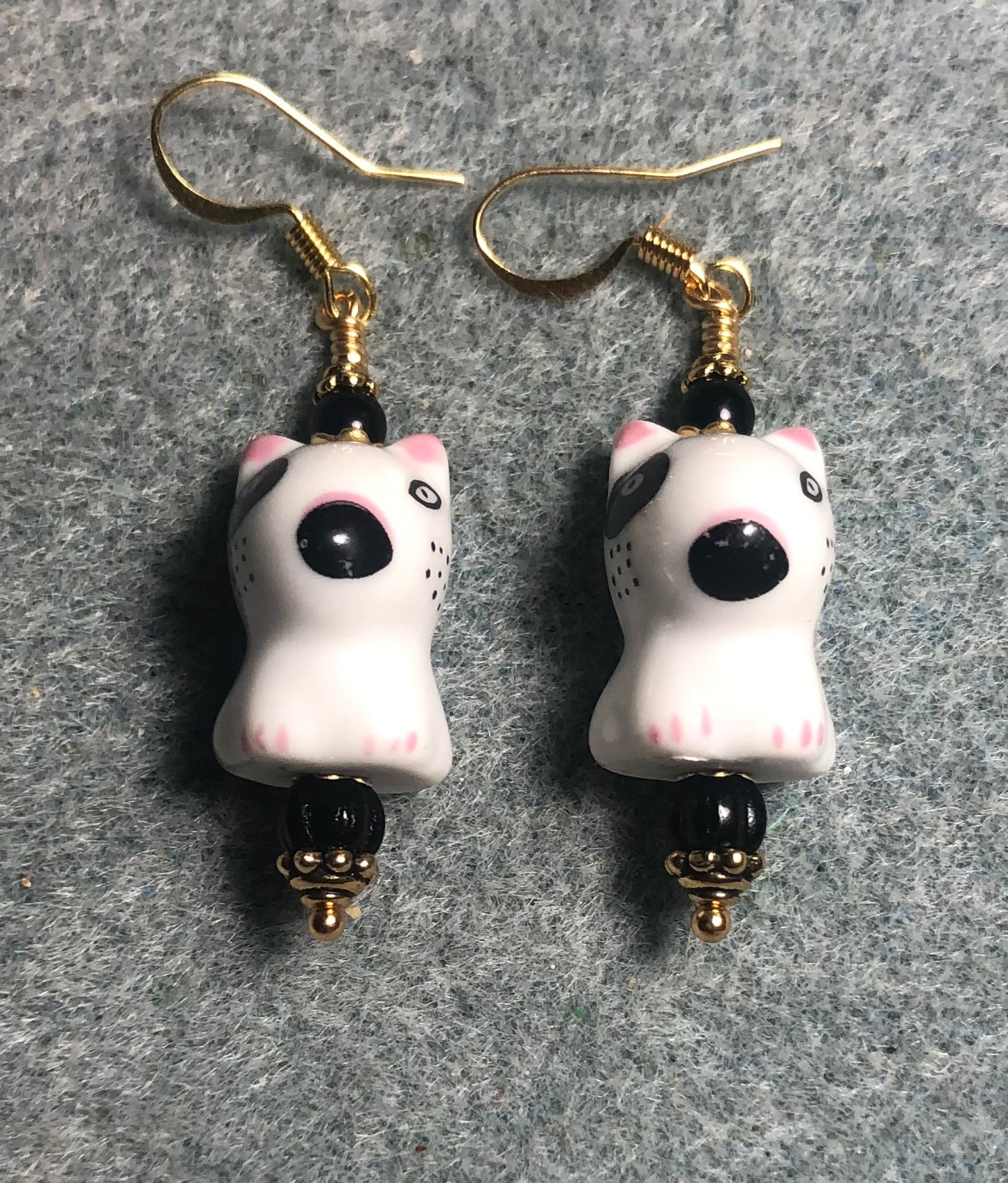 Small black and white ceramic Spuds MacKenzie puppy dog bead earrings adorned with black Czech glass beads.
