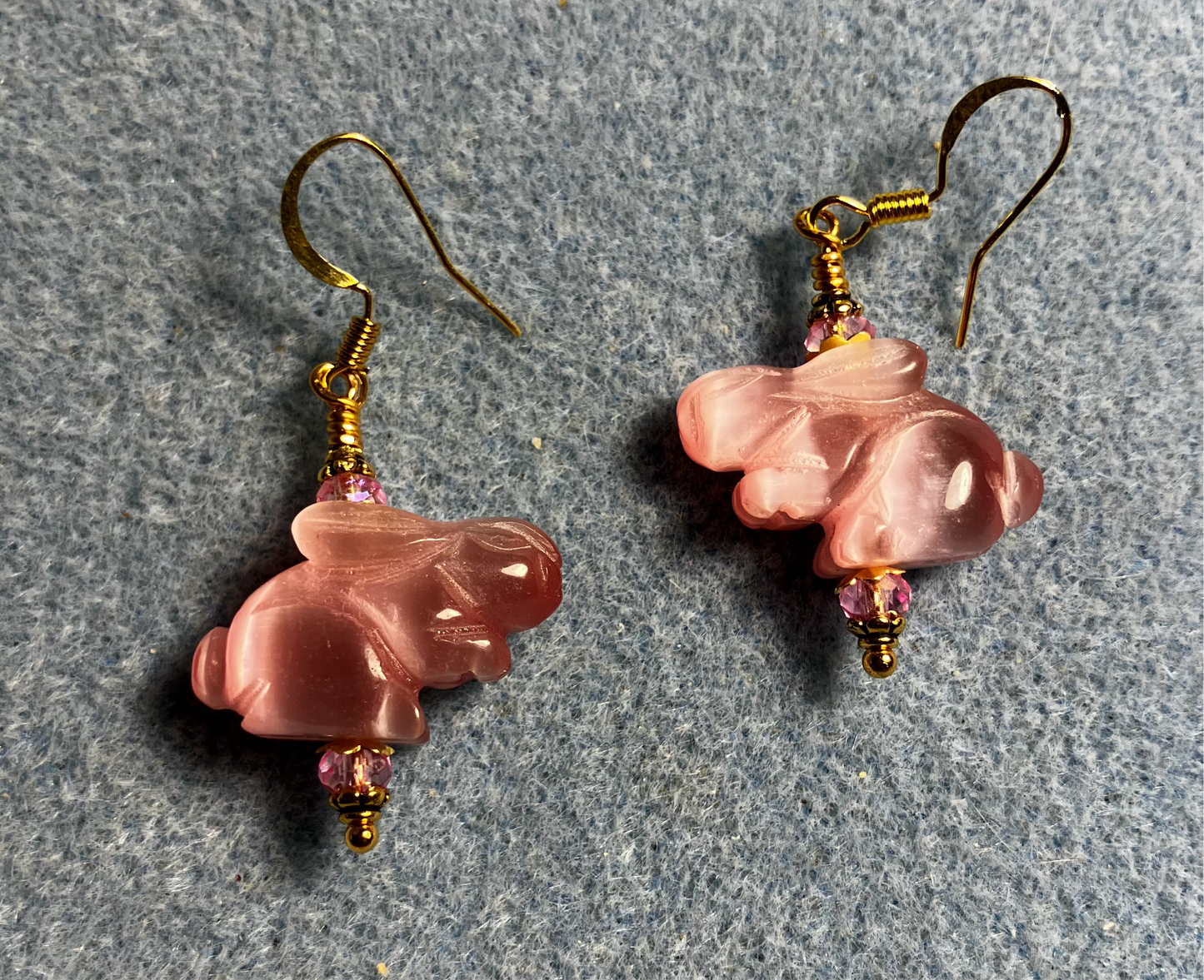 Pink fiber optic (cat’s eye) rabbit bead earrings adorned with pink Chinese crystal beads.