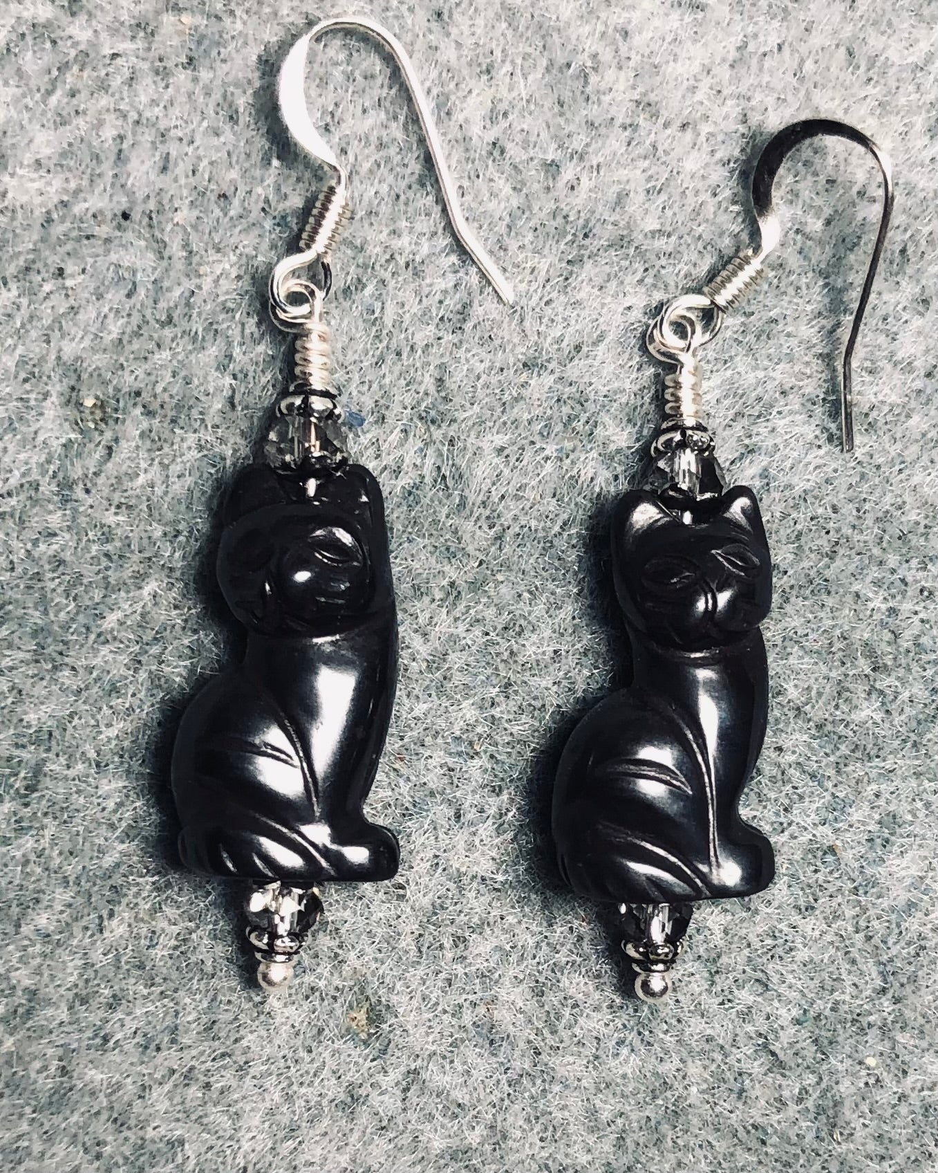 Gray hematite gemstone cat bead earrings adorned with gray Chinese crystal beads.