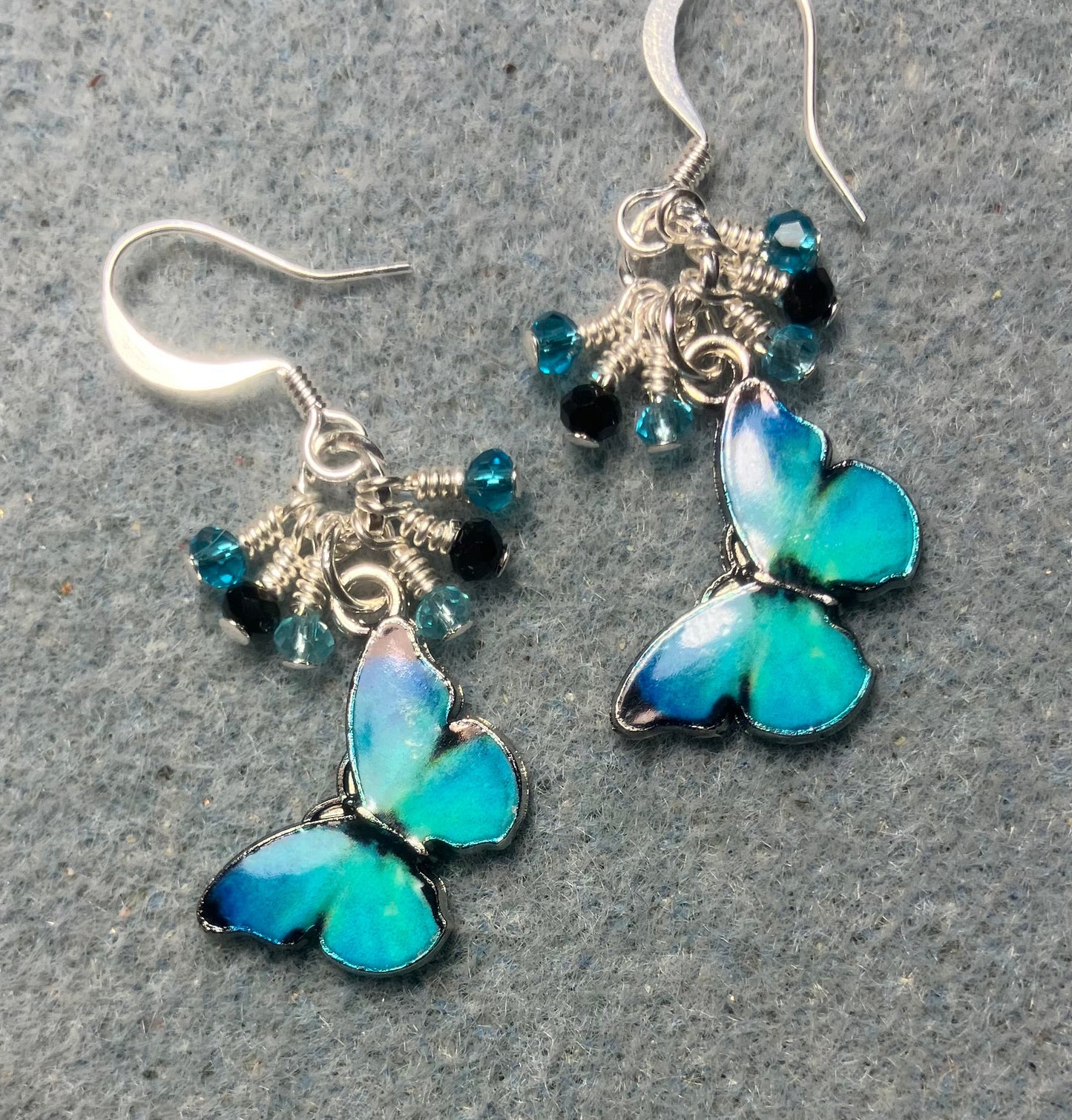 Turquoise and black enamel butterfly charm earrings adorned with tiny dangling turquoise and black Chinese crystal beads.