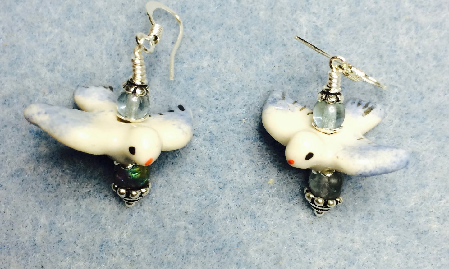 Light blue and white ceramic flying bird bead earrings adorned with light blue Czech glass beads.