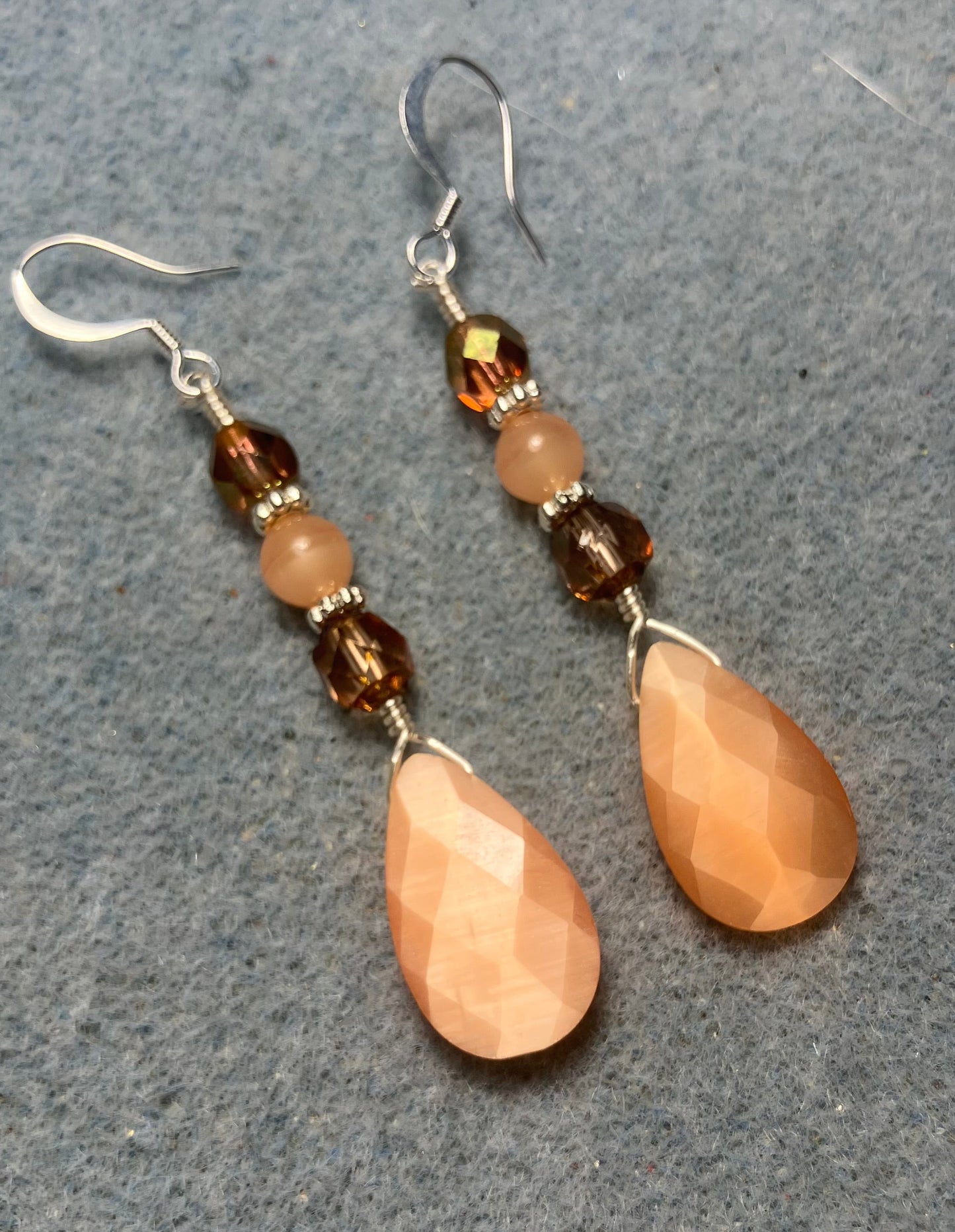 Peach fiber optic briolette bead earrings adorned with peach Czech glass beads.