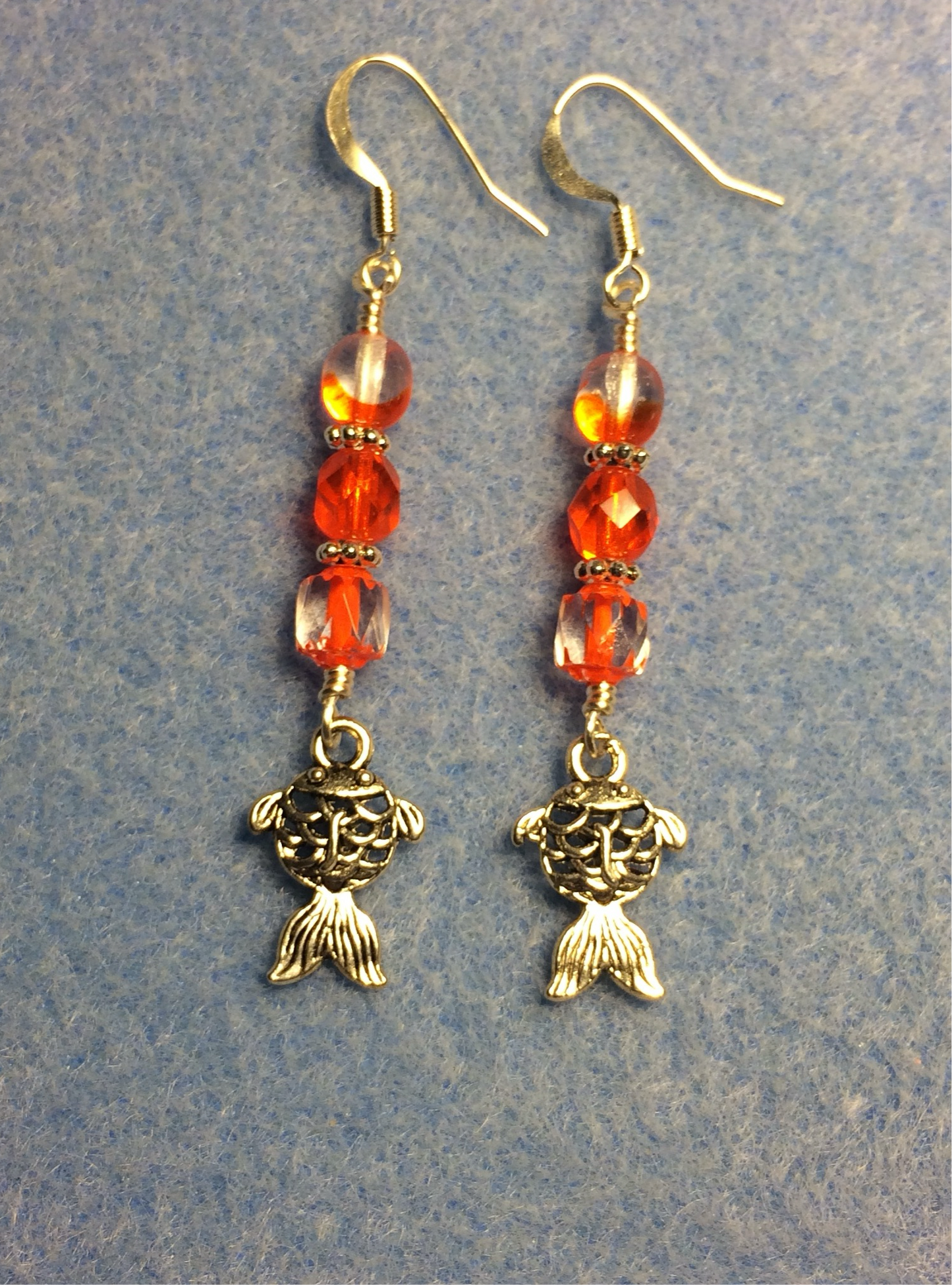 Silver goldfish charm earrings adorned with bright orange Czech glass beads