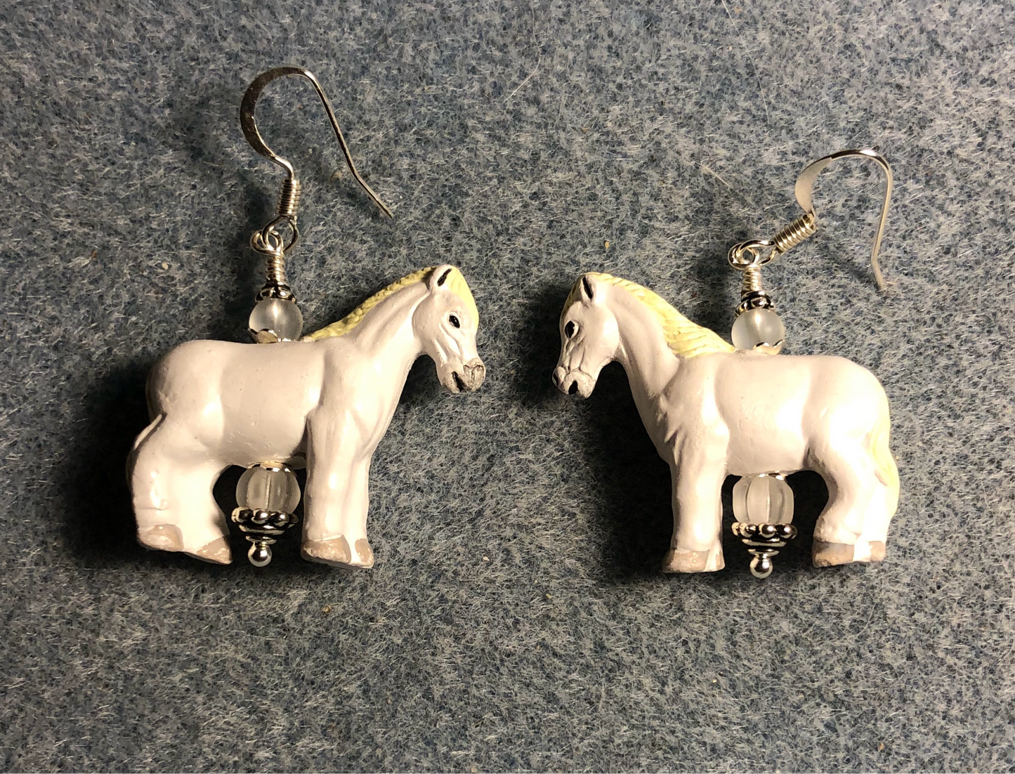 Large white ceramic horse bead earrings adorned with clear Czech glass beads.