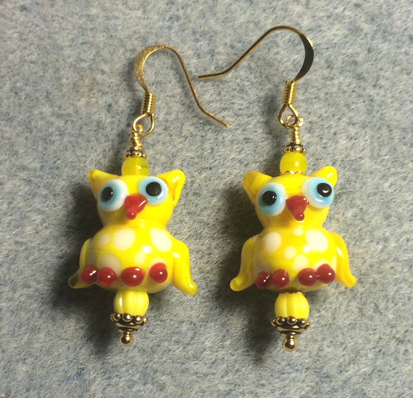 Yellow and red lamp work spotted owl bead earrings adorned with yellow Czech glass beads.