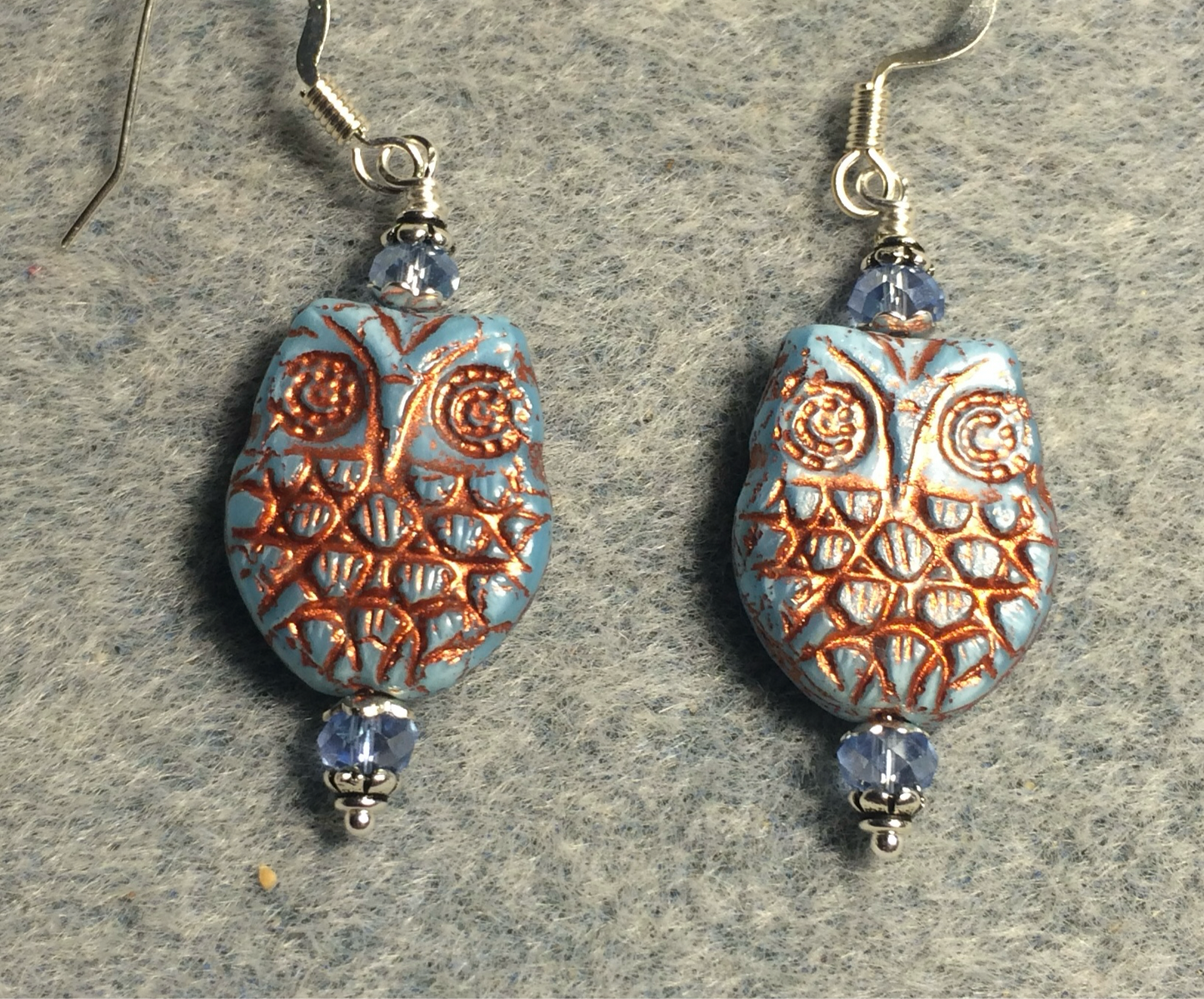Light blue (with copper wash) Czech glass owl bead earrings adorned with light blue Chinese crystal beads.