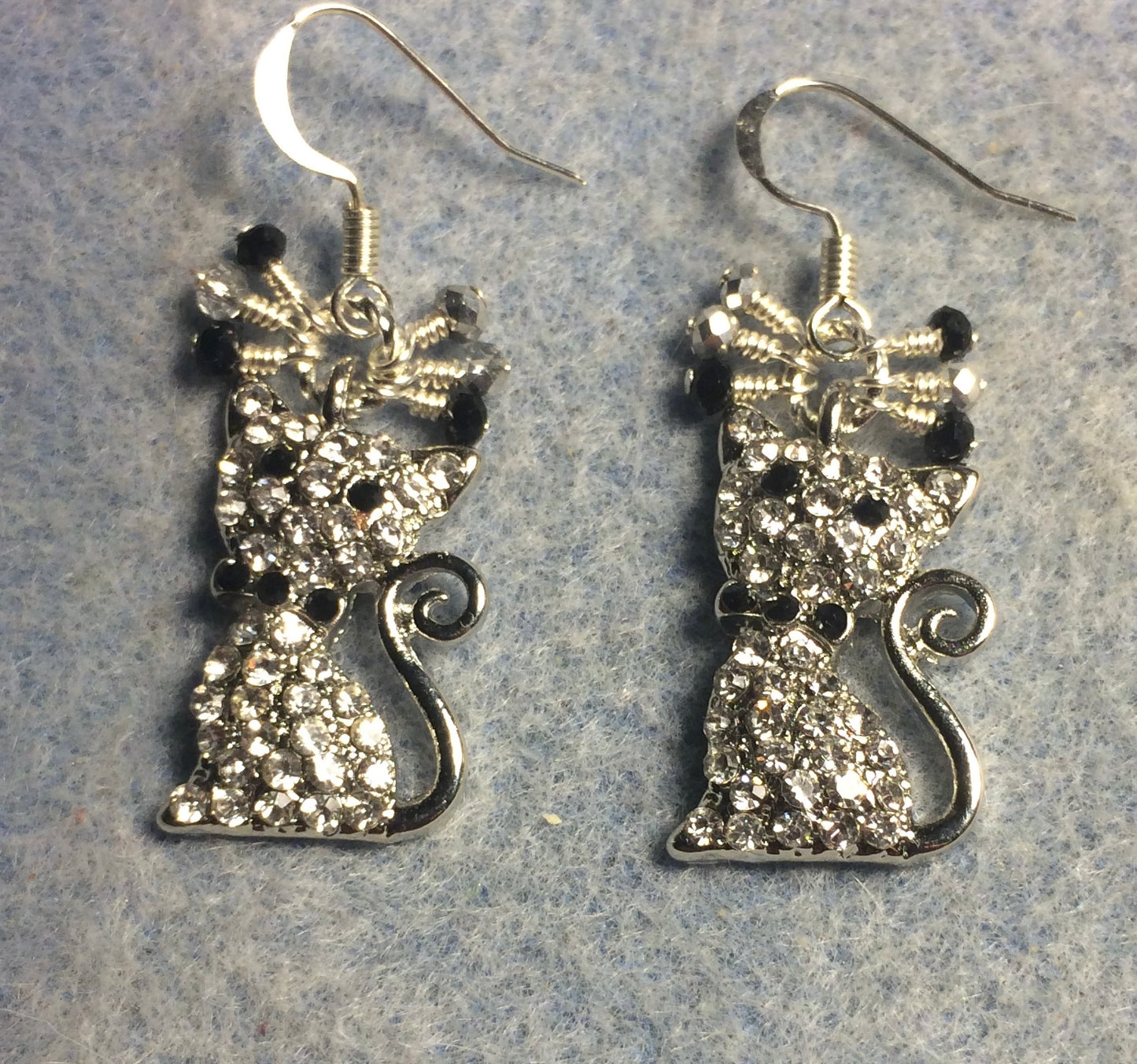 Clear and black rhinestone cat charm earrings adorned with small dangling silver and black Chinese crystal beads.