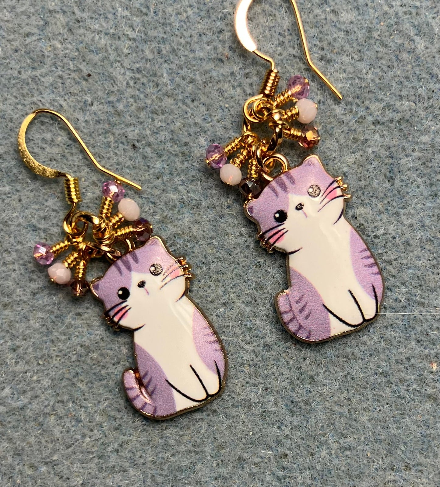 Violet and pink enamel cat charm earrings adorned with tiny dangling violet and pink Chinese crystal beads.