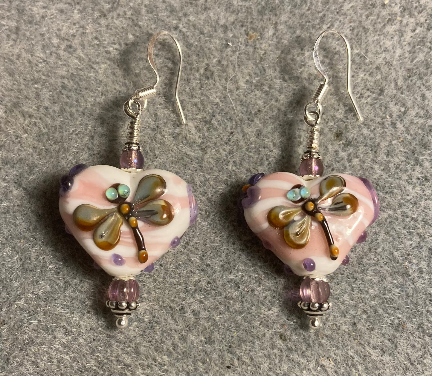 Off white and violet heart shaped lamp work dragonfly bead earrings adorned with violet Czech glass beads.