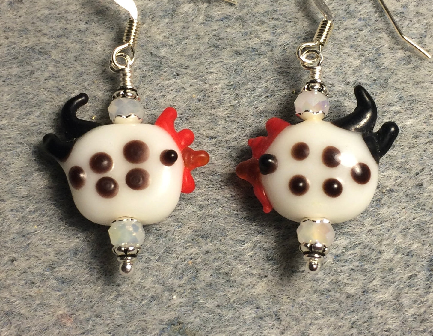 Small white with black spots lamp work rooster bead earrings adorned with white Chinese crystal beads.