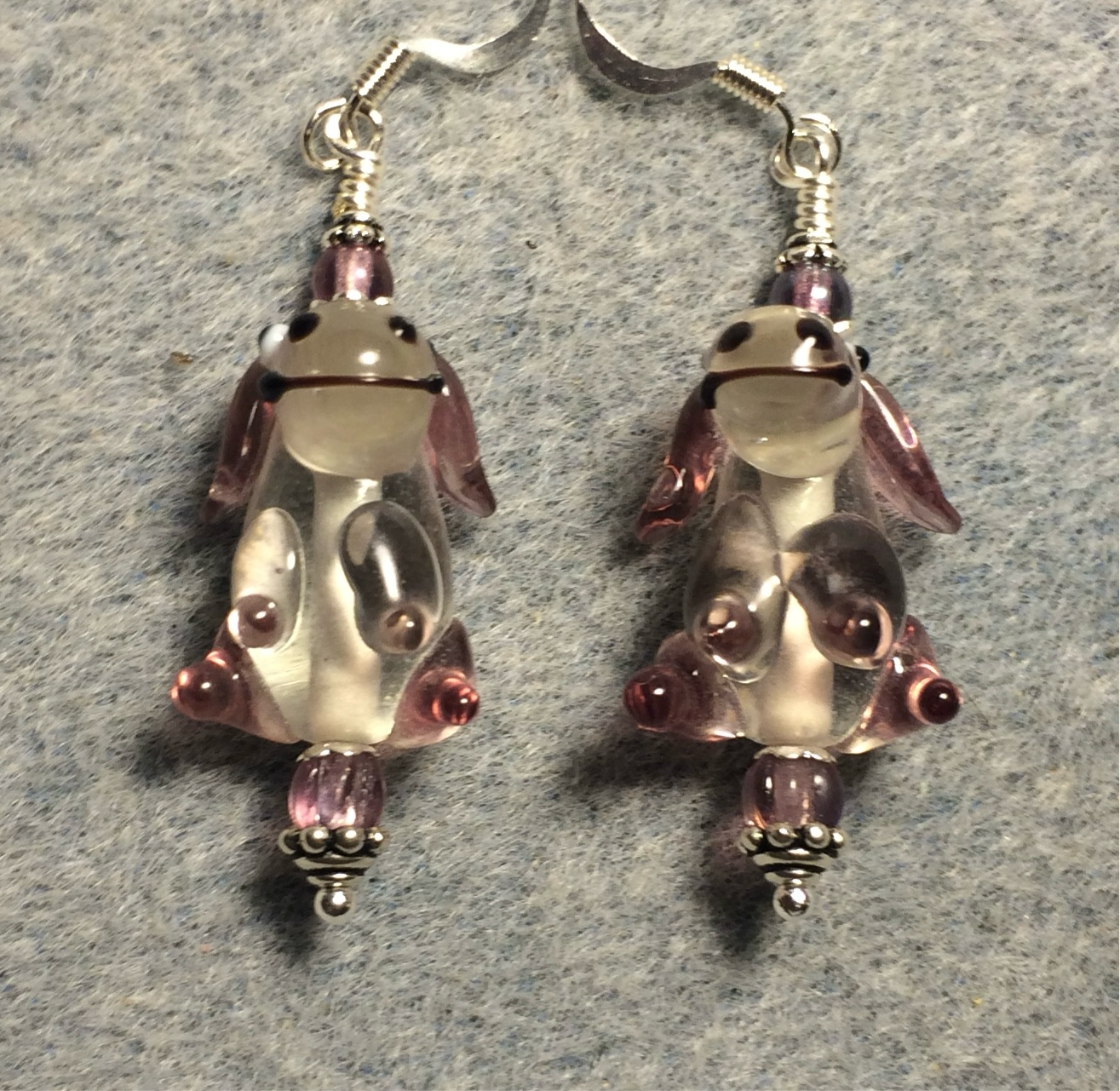 Lavender and clear lamp work puppy dog bead earrings adorned with lavender Czech glass beads.
