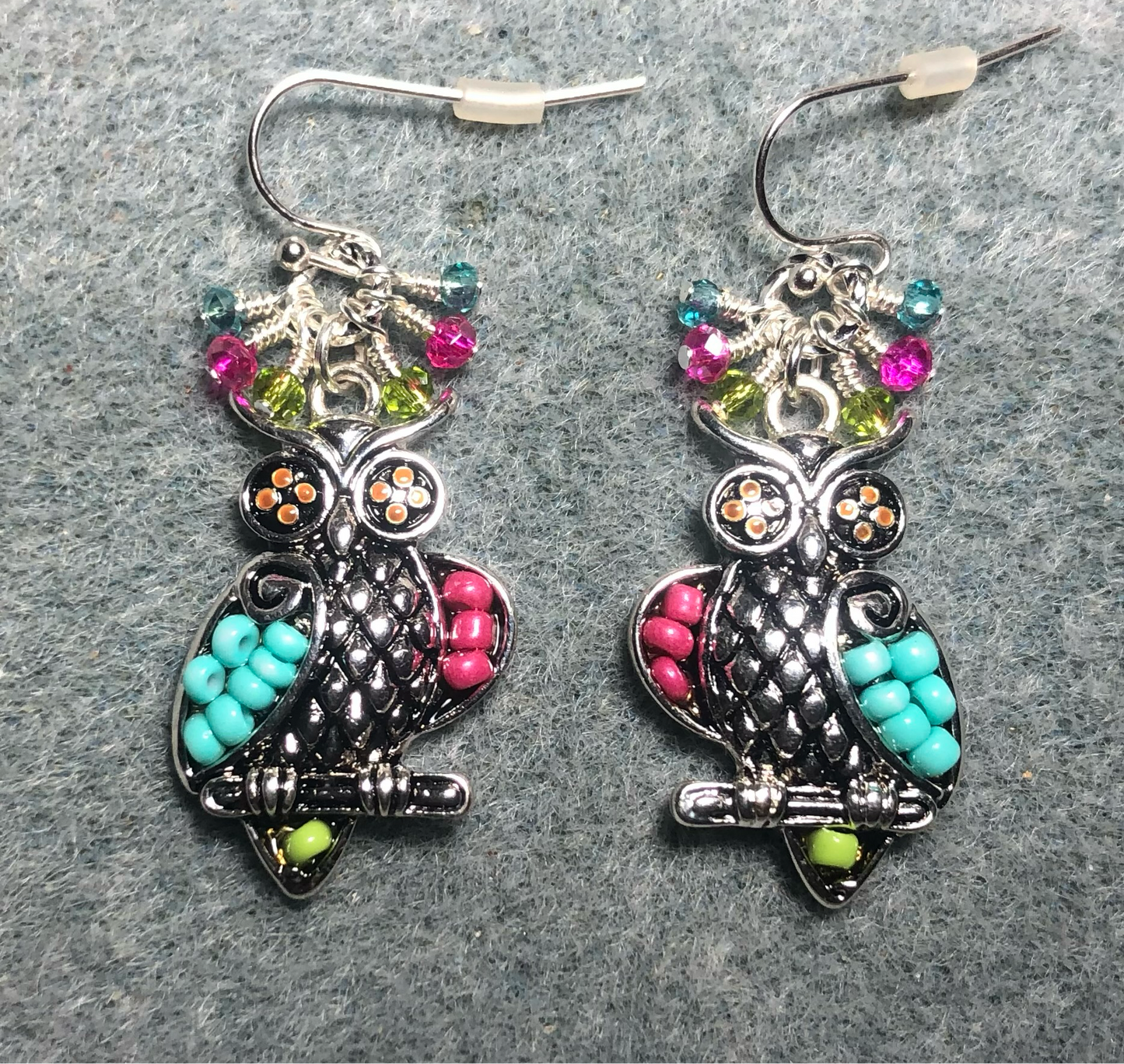 Silver, hot pink, aqua, and green seed bead owl charm earrings adorned with tiny dangling hot pink, aqua, and green Chinese crystal beads.