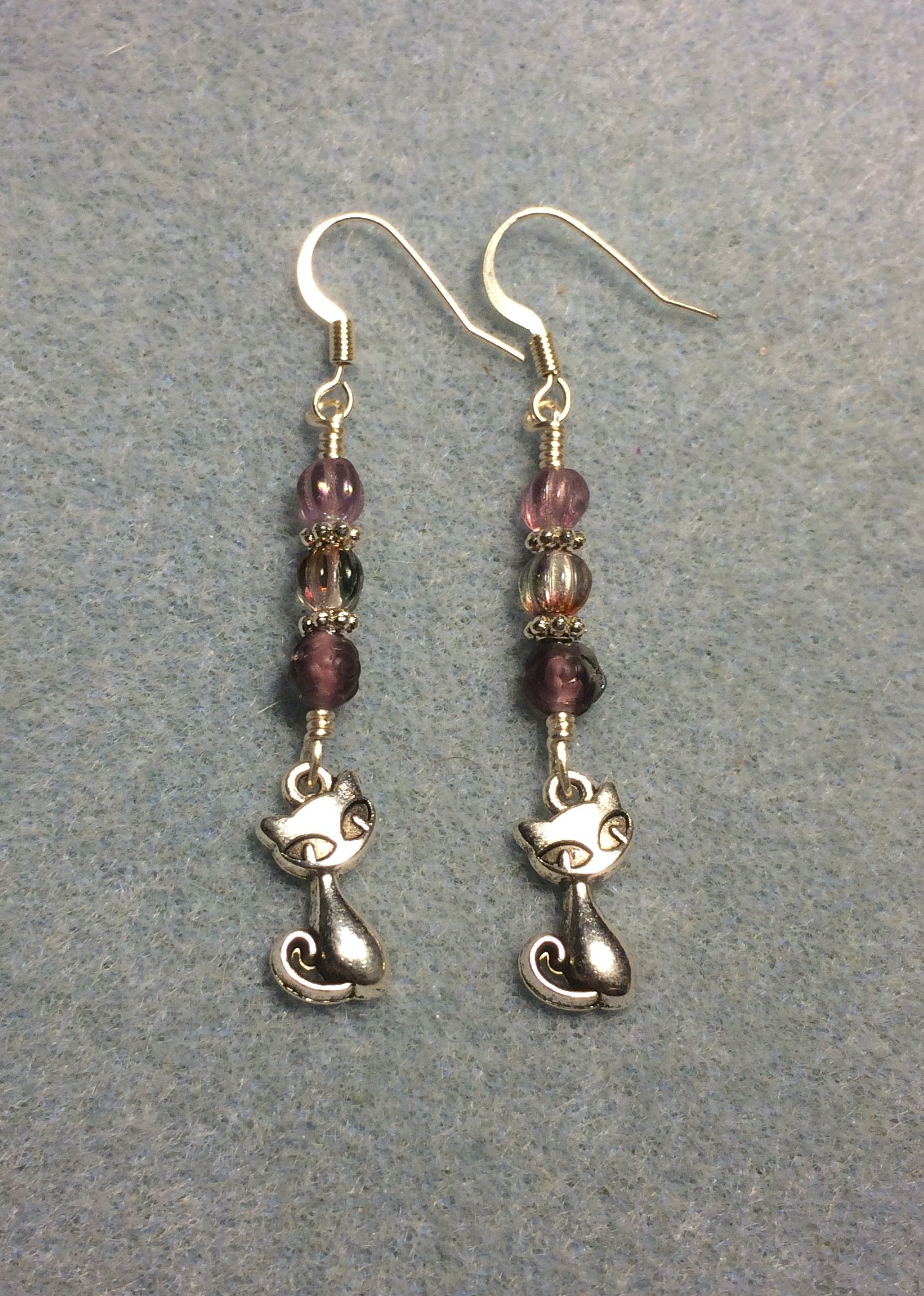 Small silver cat charm earrings adorned with small violet Czech glass beads